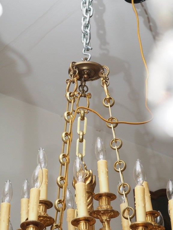 19th century French gilt bronze Louis XVI chandelier with eighteen lights in the form of an arrow quiver with foliate scrolls surmounted with candle cups.
