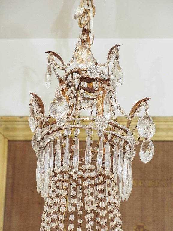 Italian gilt metal and crystal beaded Empire form chandelier, circa 1900.