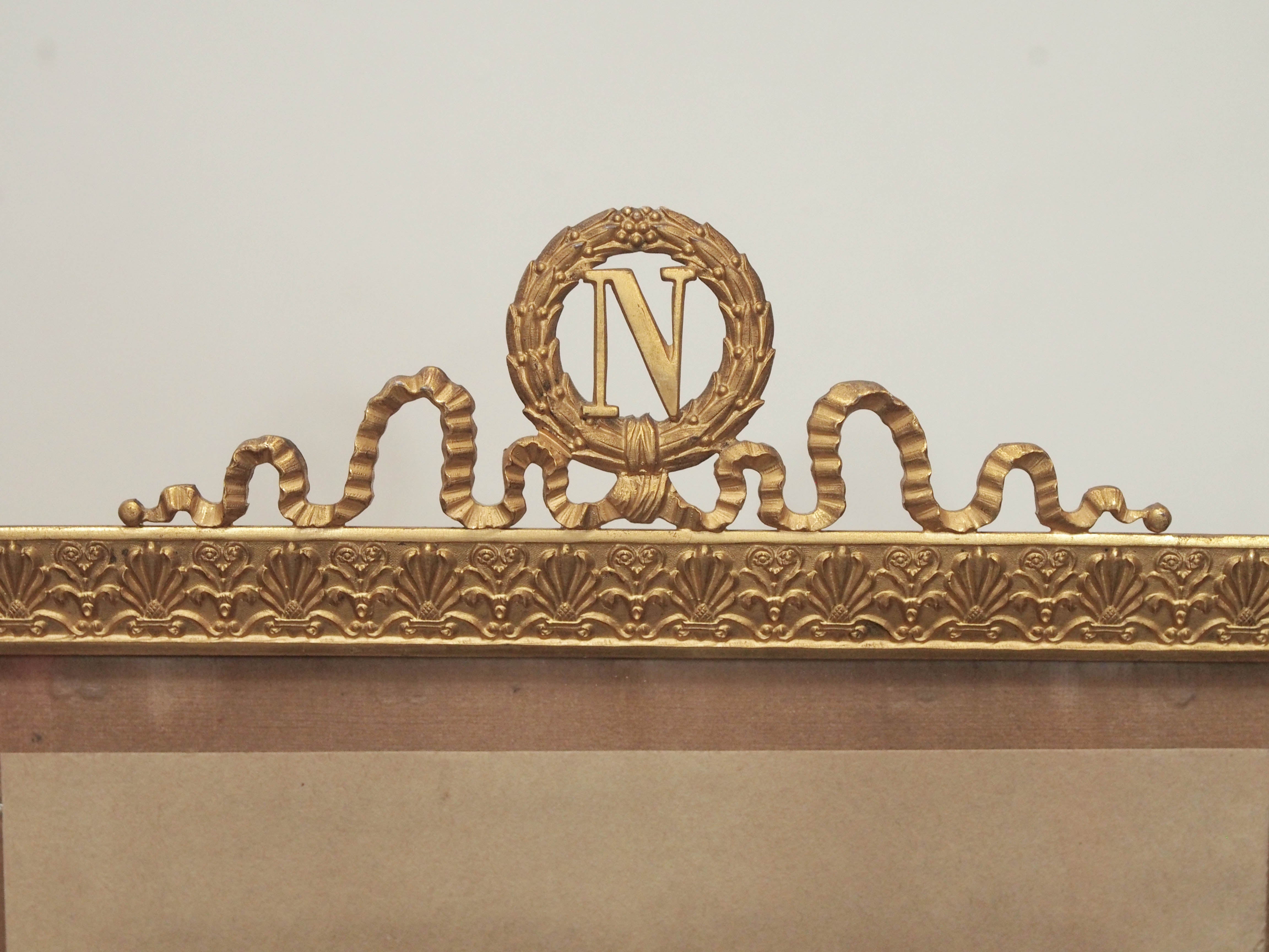 French Napoleonic Gilt Bronze Frame circa 1900 having a patterned frame and crested by a ribboned laurel wreath surrounding the Napoleonic N Crest.