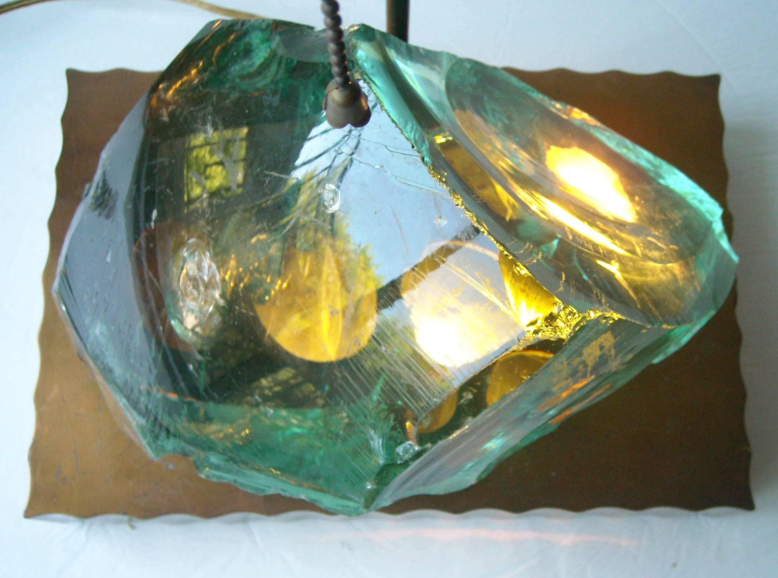 Amazing light base and table lamp with brass finish metal chunk rough glass.