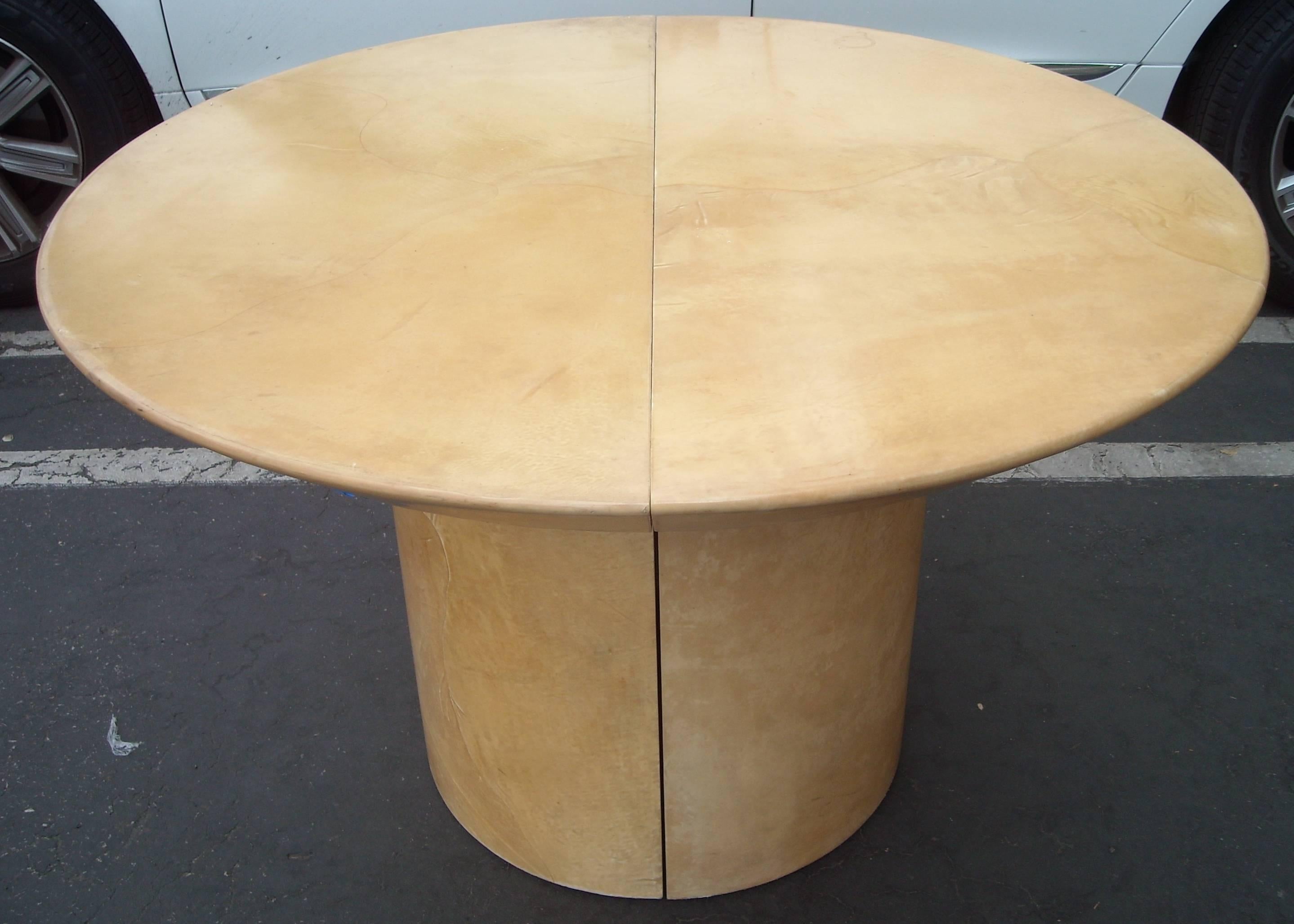 This is an amazing dining table in goatskin. We could not find any label, but there are several designers in the 1980s that have designed parchment goatskin tables, Like Sally Sirkin Lewis , Karl Springer, etc. This table is round and diameter of 48
