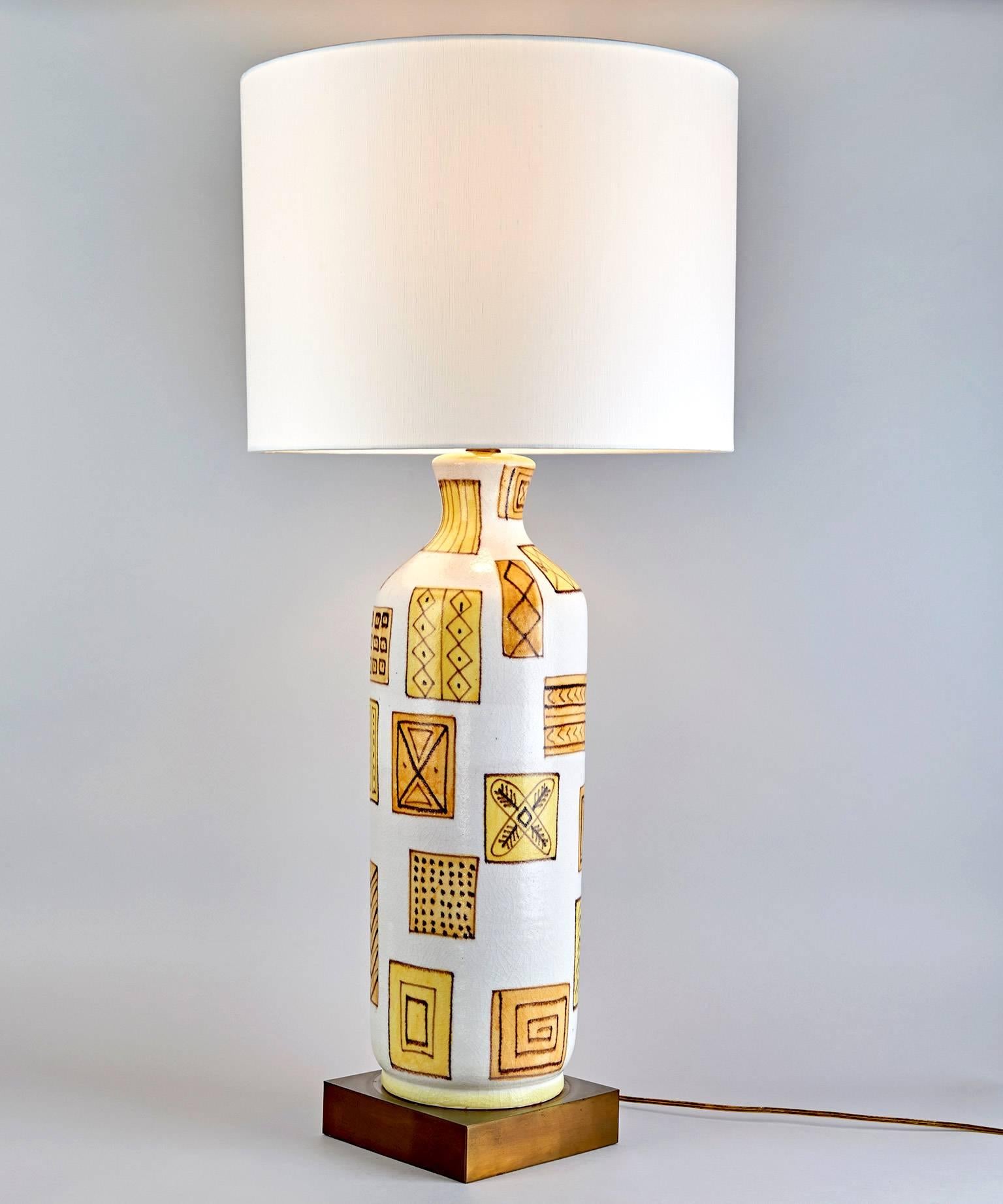 A graphically stunning ceramic table lamp by postwar Italy's greatest ceramist, Guido Gambone. The enigmatic design of intricately but spontaneously decorated squares and rectangles is arrayed over the surface of the ceramic lamp-base with the