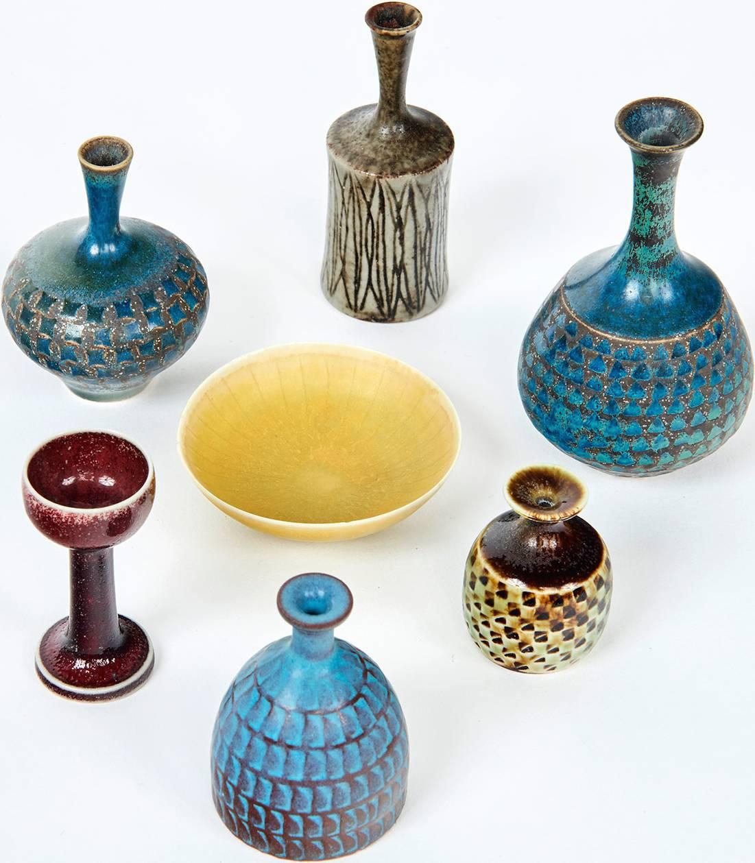 Nothing displays the mastery of a ceramist better than the ability to throw, on a potter's wheel, perfectly formed vessels of ridiculously small dimensions. Made with special wooden tools, these miniature stoneware vessels -- five vases, a chalice,