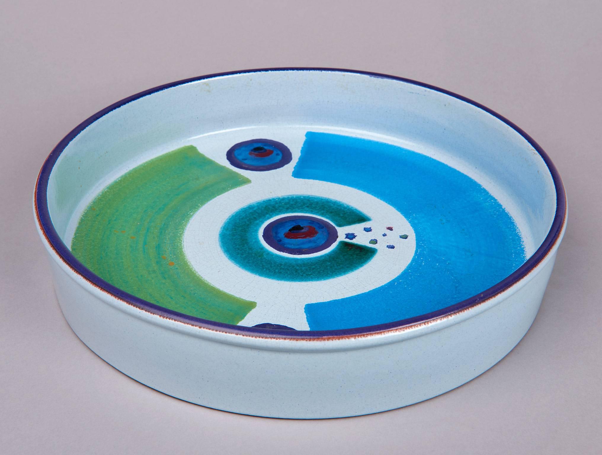 A lovely bowl, glazed with a hand-painted abstract design that suggests Stig Lindberg was an enthusiast of Ettore Sottsass's early ceramics. Signed with the Gustavsberg Studio mark, and the personal mark of the painter, Karin Björquist (Björquist is