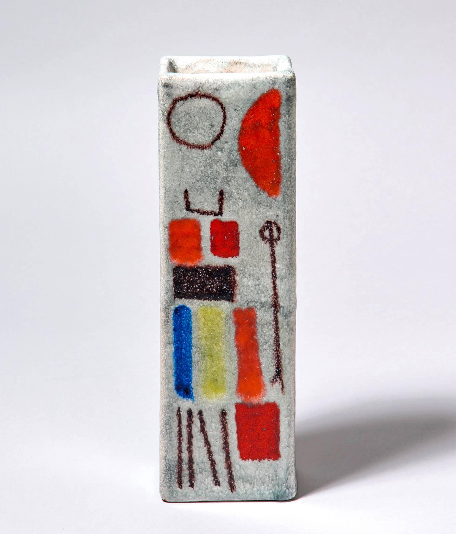 An excellent slab-built vase of rectangular section, made in the early 1950s by Guido Gambone, post-war Italy's most celebrated ceramist. Decorated with abstract, almost glyphic designs in orange, red, yellow, blue, and aubergine. Signed with the