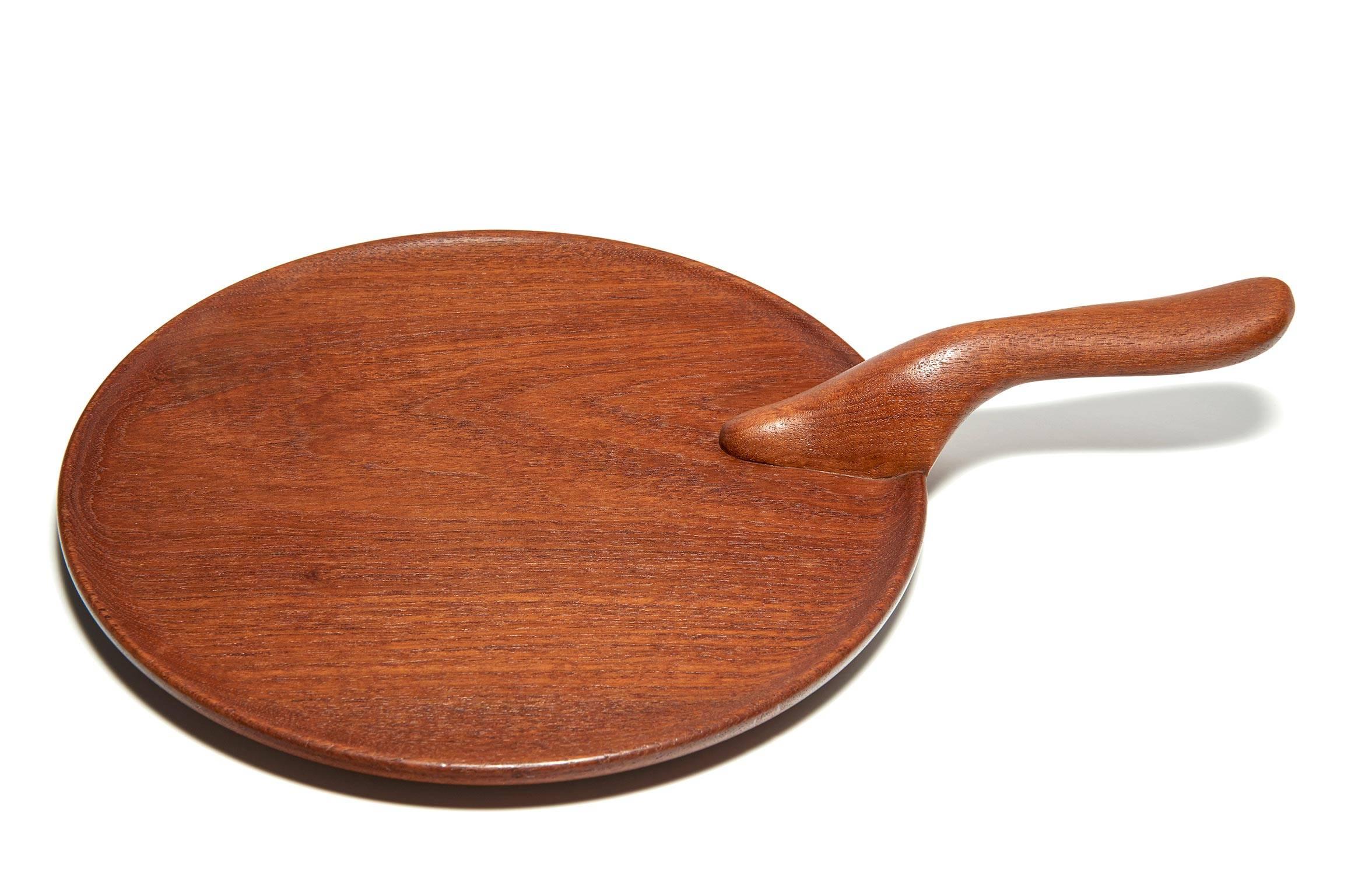 Give a legendary Danish artisan a slab of Siamese teak, and he'll do something wonderful with it. This old Kay Bojesen handled serving tray is distinguished by a beautifully formed and carved handle that makes it a tactile delight to carry around as