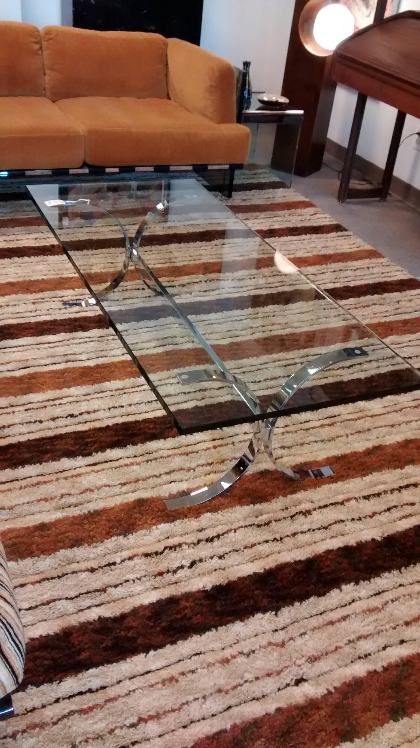 Superb example of a Milo Baughman coffee table. Dating to about 1970, and just retrieved from its original location. 

Curved X-form chrome over steel base and stretcher, with its original 3/4