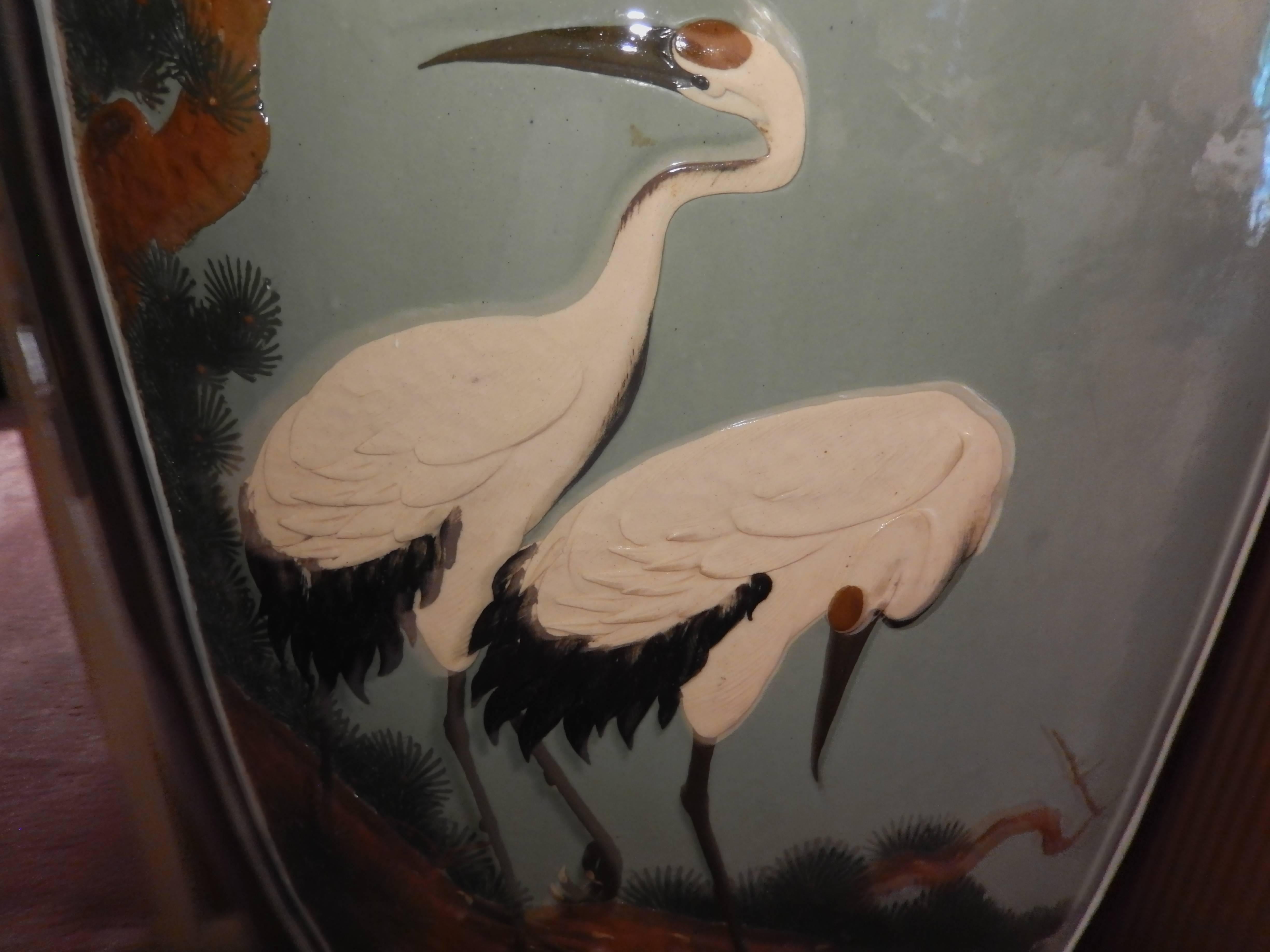 Massively scaled Chinese lacquerware urns, dating to the early 20th century. Raised on coordinating lacquered stands, which appear to be original to the pair. 

Reserve decoration includes images of cranes resting on a branch. Excellent overall