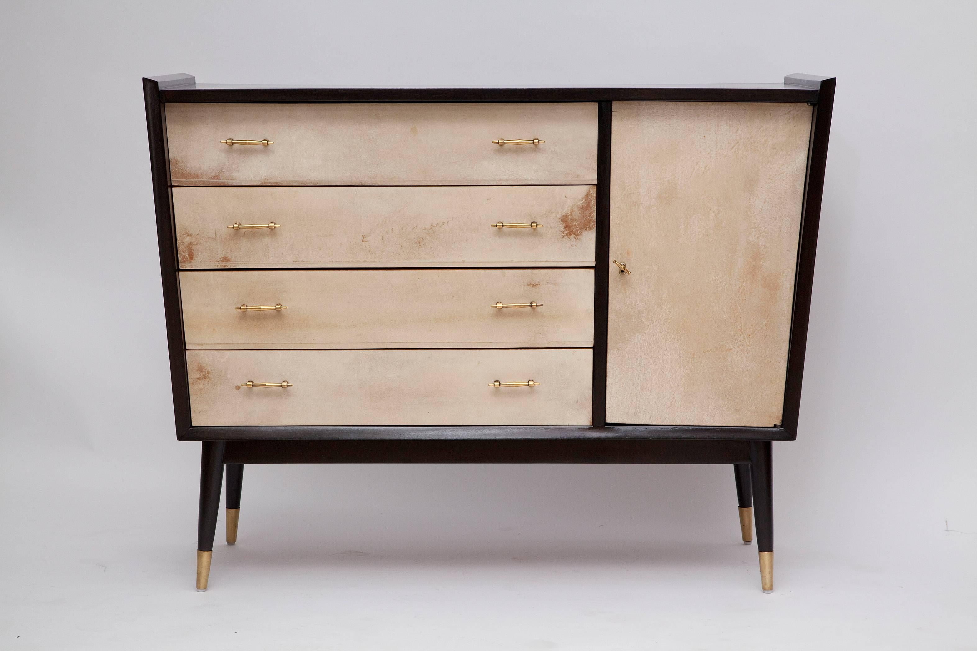 Angular 1950s modernist design teams up with interesting solid brass hardware and rich materials to make this beautifully restored French ebonized cabinet, with goatskin drawer and door fronts, an eye-catching personality piece!