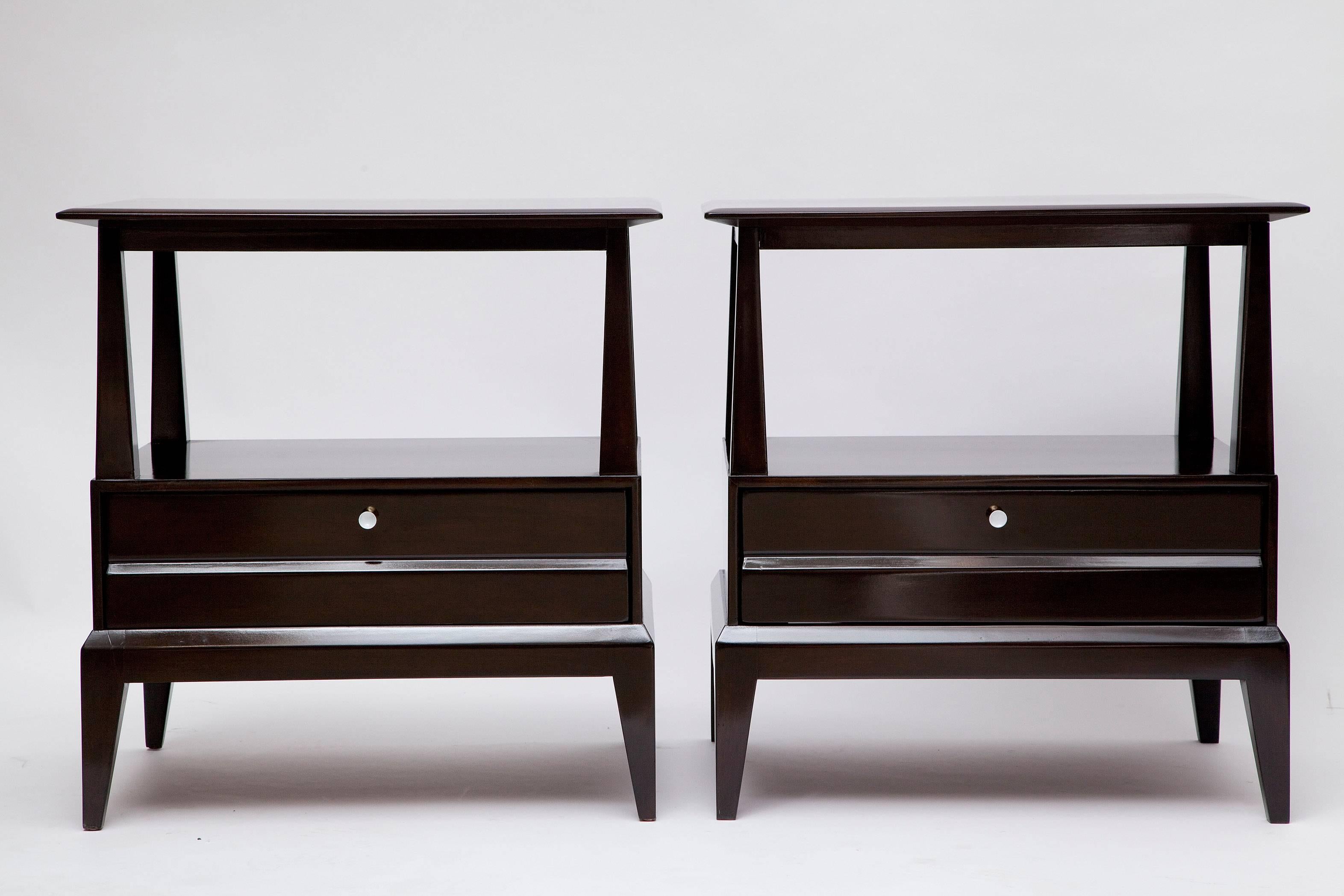 We've had this pair of 1960s Heywood-Wakefield walnut nightstands ebonized to enhance their (surprisingly) chic shapes. Original solid brass drawer pulls with white enamel centers.