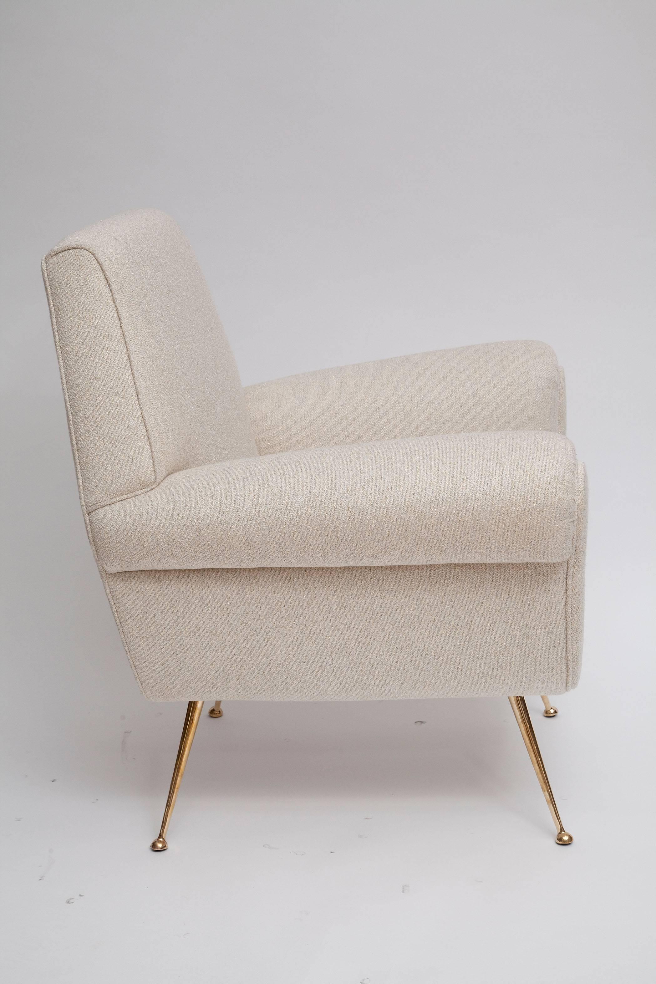 Exceptional pair of 1950s Italian lounge chairs by Gigi Radice for Minotti. Fully restored and meticulously upholstered with all new foam in creamy cotton upholstery shot through with shimmering gold lurex. Polished solid brass legs. Turn the lights