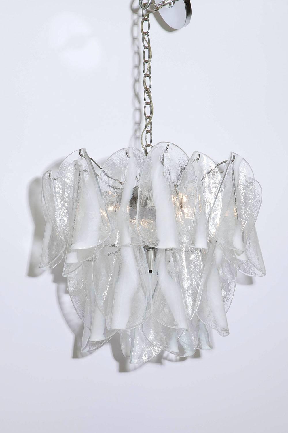 1970s Mazzega handblown clear and white Murano glass petal chandelier. Glass petals hang from a 6 light chrome-plated steel frame. Uses six 40 watt candelabra bulbs.