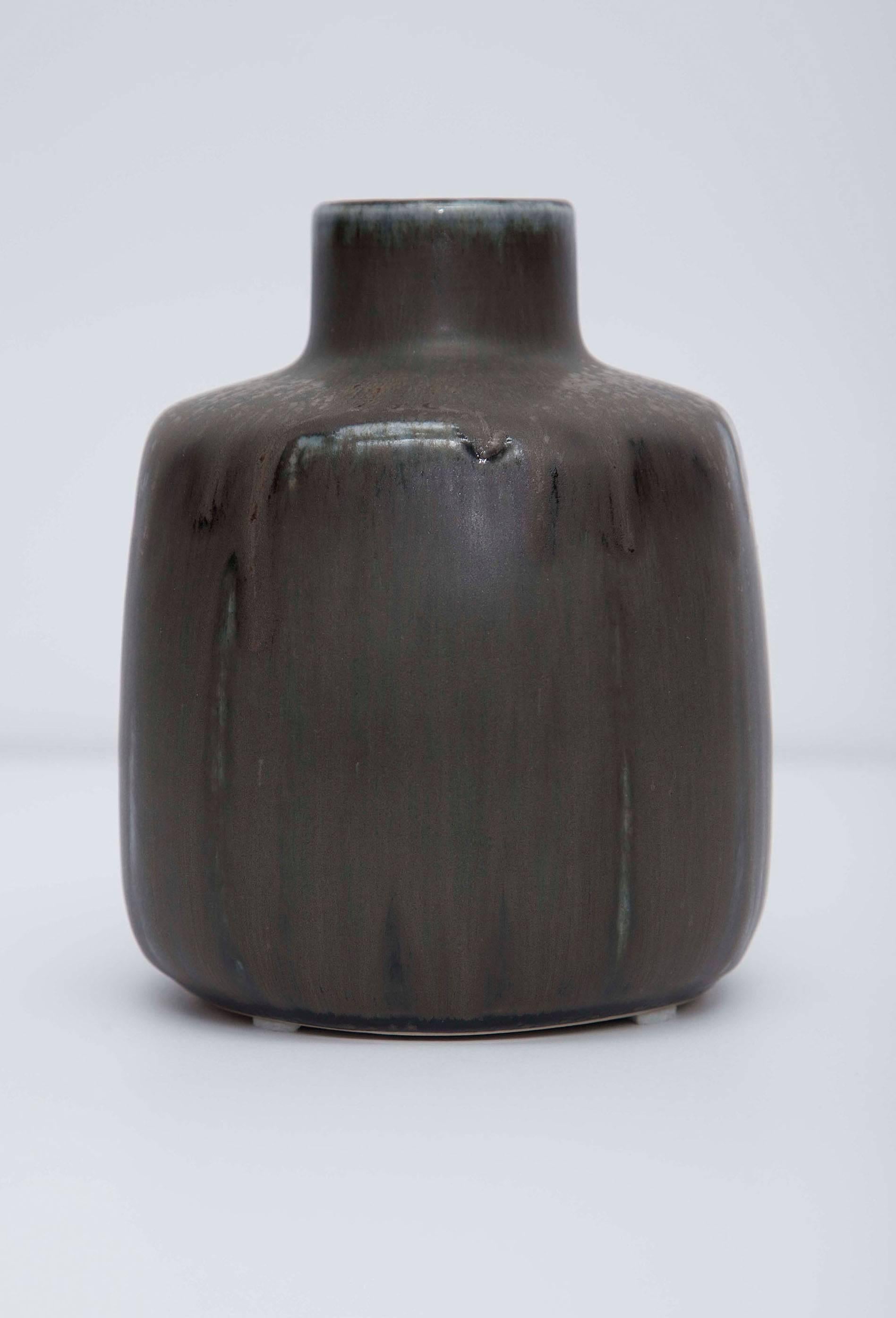 Stoneware Saxbo vase with dark brown and olive glaze by Eva Stæhr Nielsen. Rounded square body with circular raised opening. Impressed 