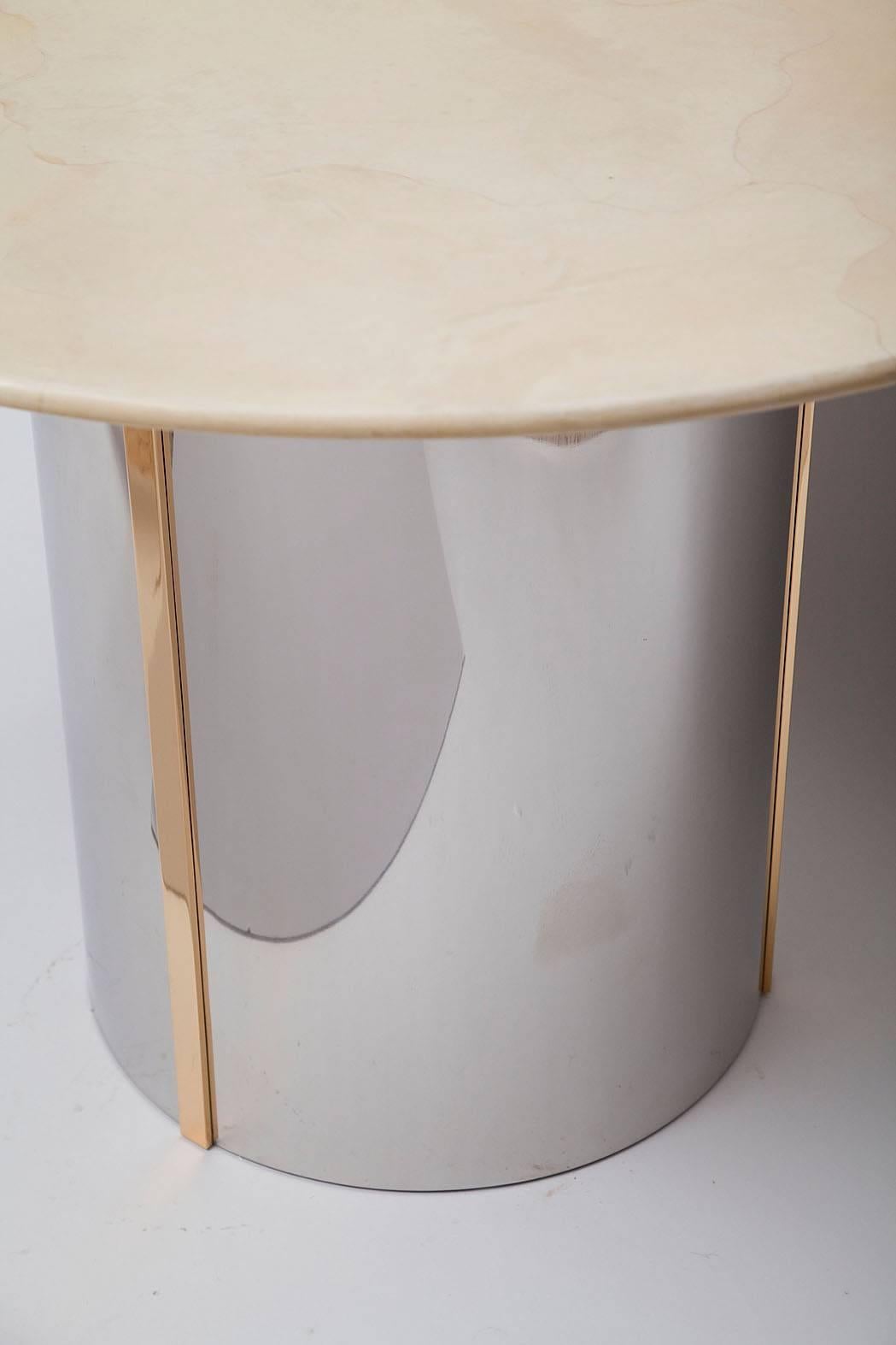 Finely-crafted Ron Seff center table in the style of Karl Springer with a polished steel and brass base and pale goatskin top, circa 1975.