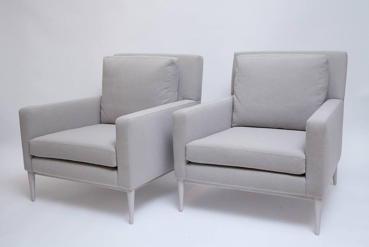Gorgeous and iconic Mid-Century pair of fully restored lounge chairs by Paul McCobb for Directional with bleached walnut legs and all new foam with down wrapped back cushions, upholstered in a pale greige Beacon Hill wool blend, super-fine bouclé.