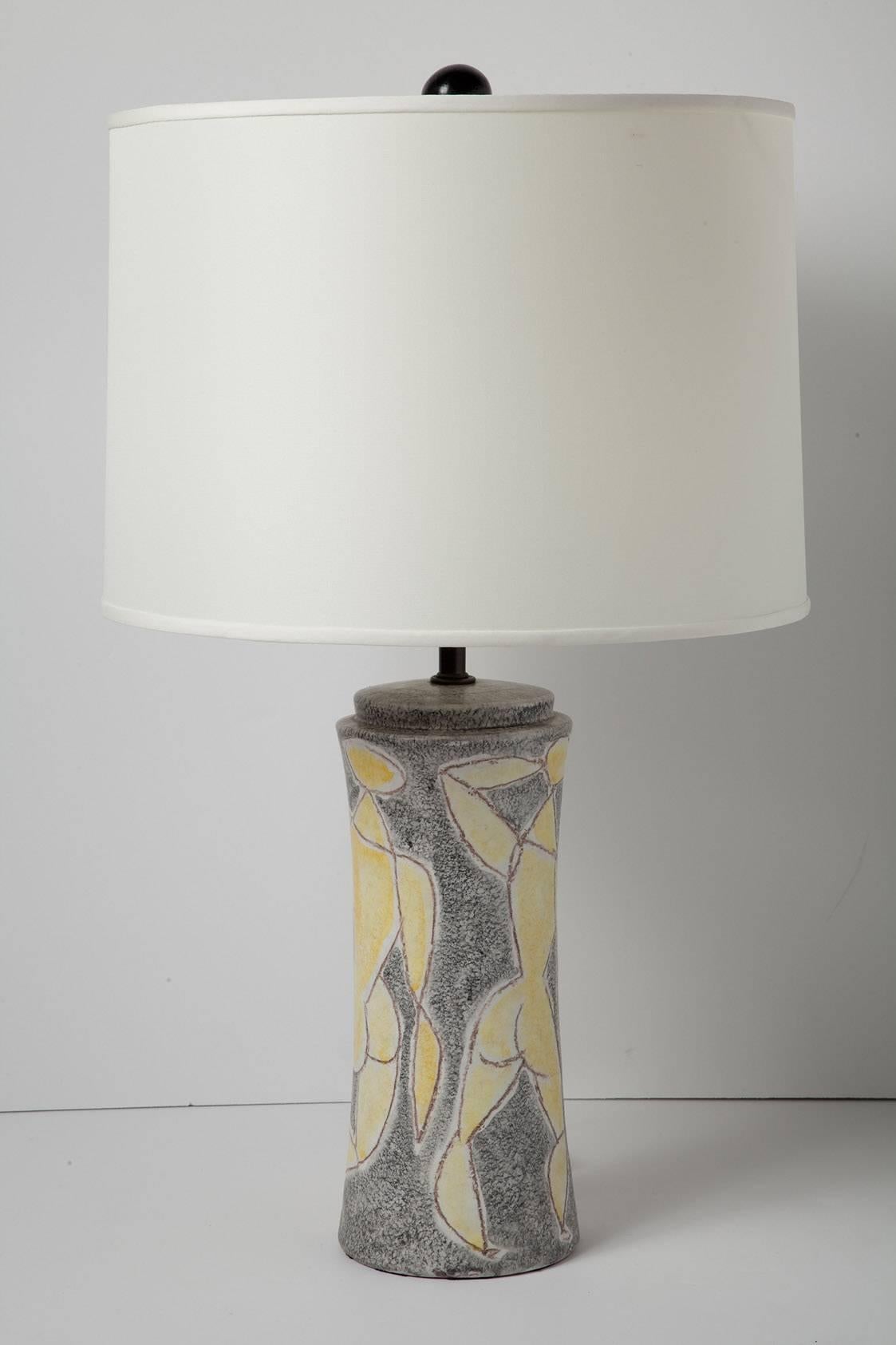 Signed 1950s Italian ceramic lamp by Marcello Fantoni, featuring captivating crayon-style figural drawings. Signed on verso. (Lamp only. Shade, harp and finial not included.) Height measurement is 17.5