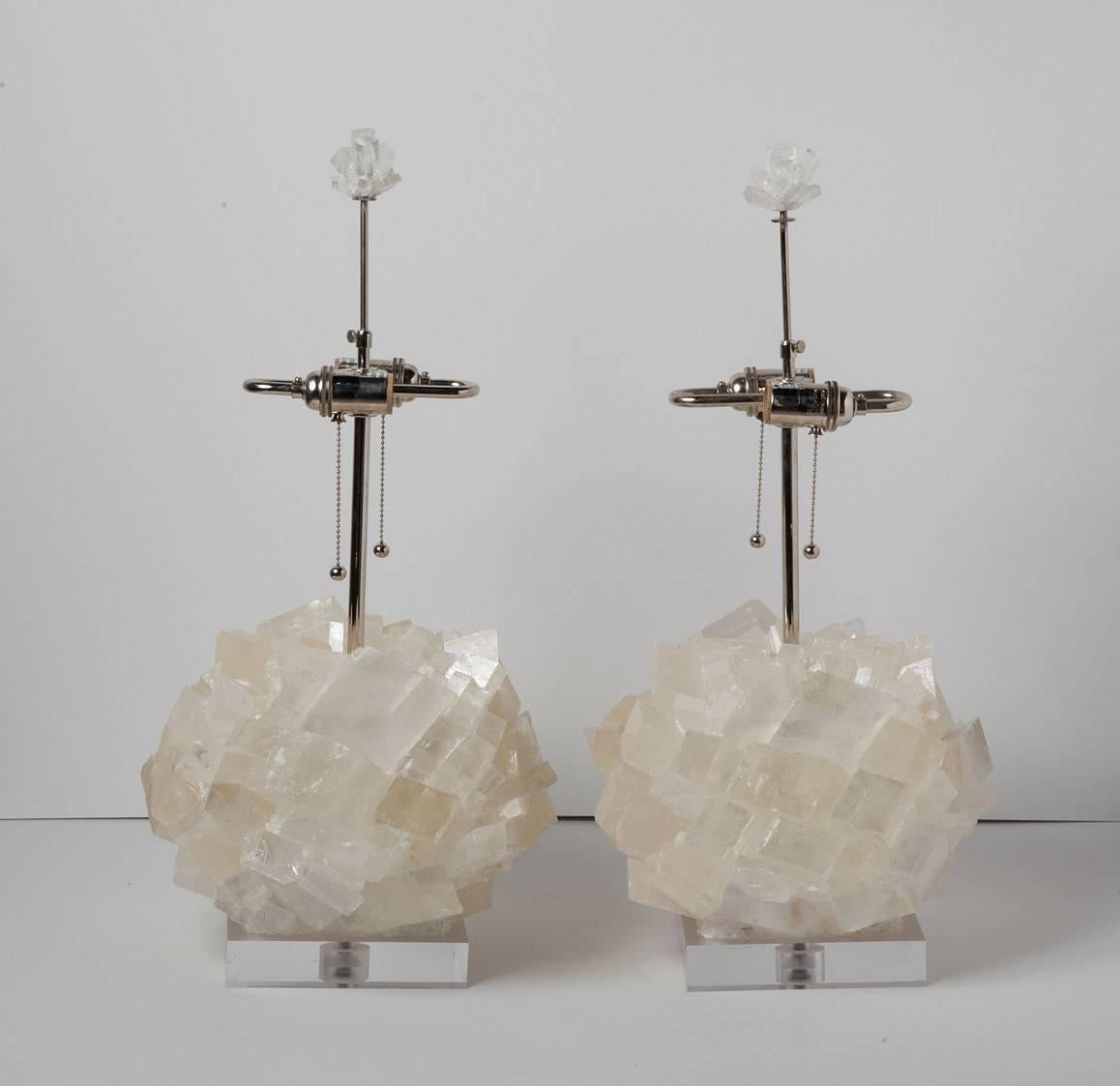 Glamorous natural crystal table lamps by Kathryn McCoy in prismatic optical calcite on acrylic bases. Fabric cord and nickel hardware, with matching crystal finials. Height measurement below is to top of finial. (Shades not included).