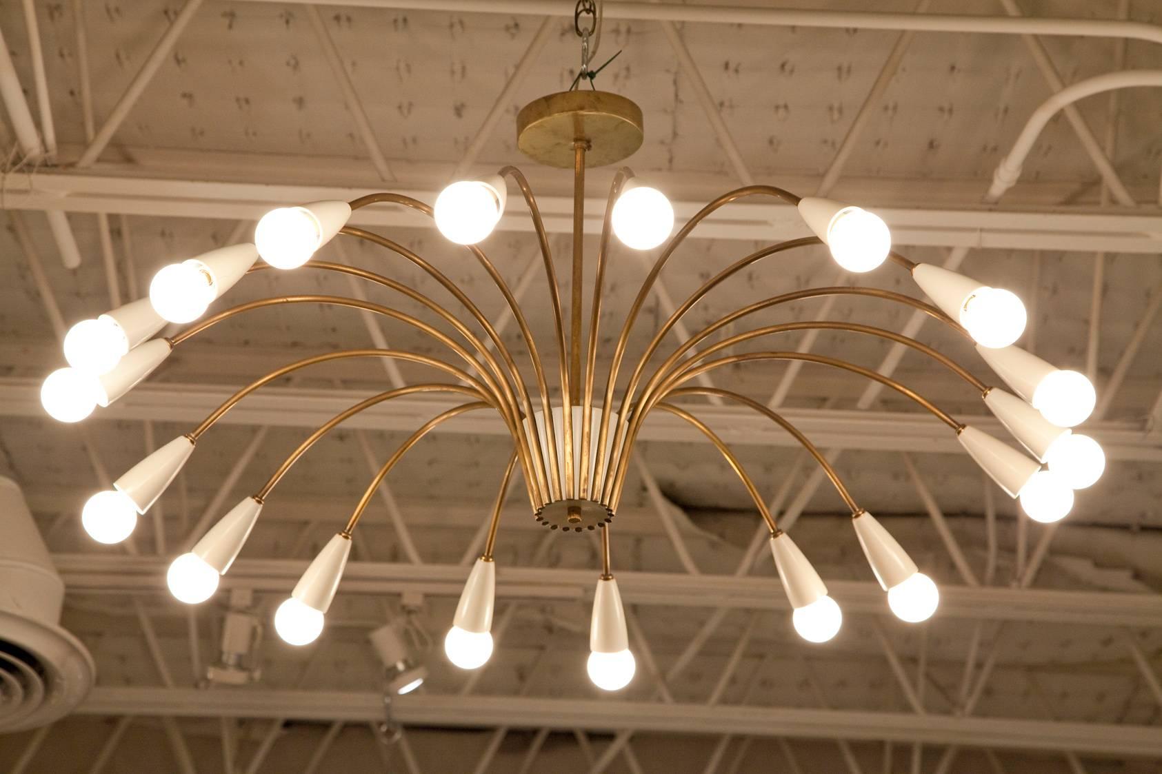 A large-scale, 18-light, brass and cream enamel 1950s, Italian spider chandelier in the manner of Stilnovo. Gently restored and professionally hand-polished to retain a soft, warm patina to the brass. Re-wired for U.S.