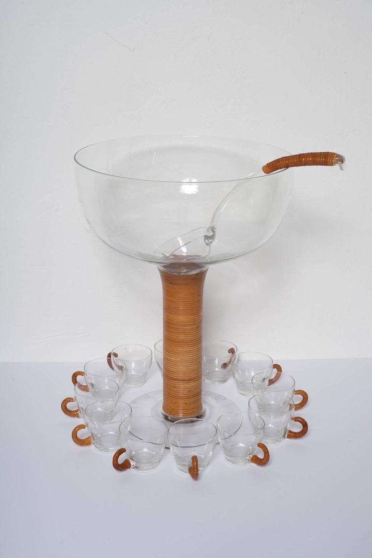 Whimsical punch bowl set in wicker wrapped glass in the manner of Aubock, Austria circa 1955. Set features tall punch bowl, ladle, twelve cups and one serving item (shown in last detail photo).