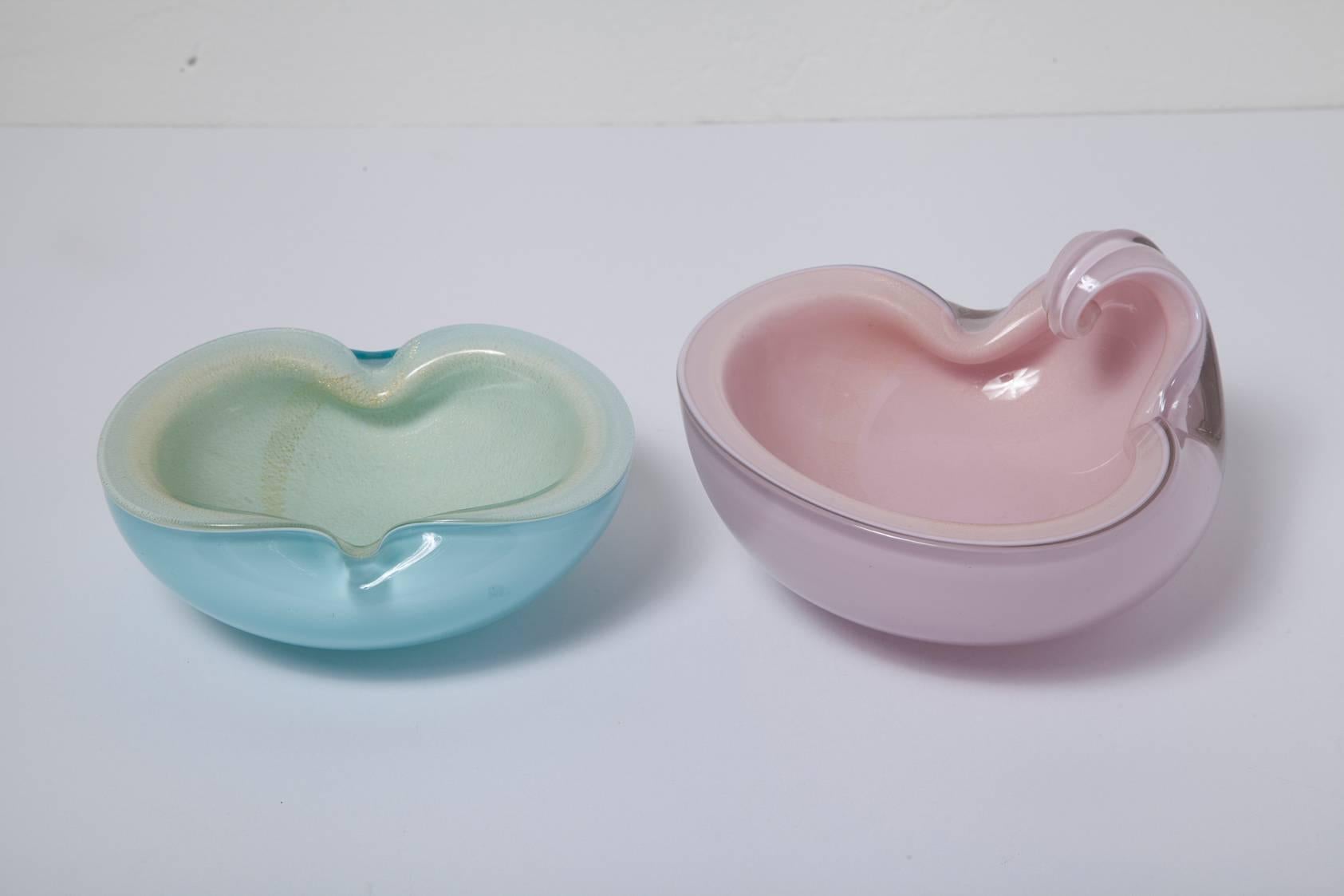 Perfect for holiday gift giving two 1950s Murano glass bowls by Barbini. The first is gold dusted pale pink cased in clear glass and measures H 3.75 in. x W 7 in. x D 6.75 in. The second is gold dusted white cased in pale blue glass and measures H