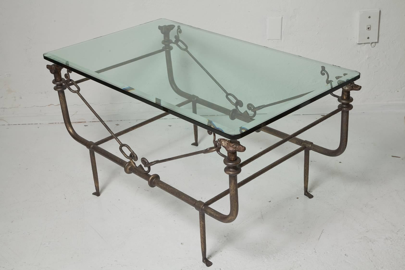 Unique Giacometti-style iron coffee table in patinated bronze finish with 0.5 in. beveled glass top supported by whimsical foxes at each of its corners, circa 1970.