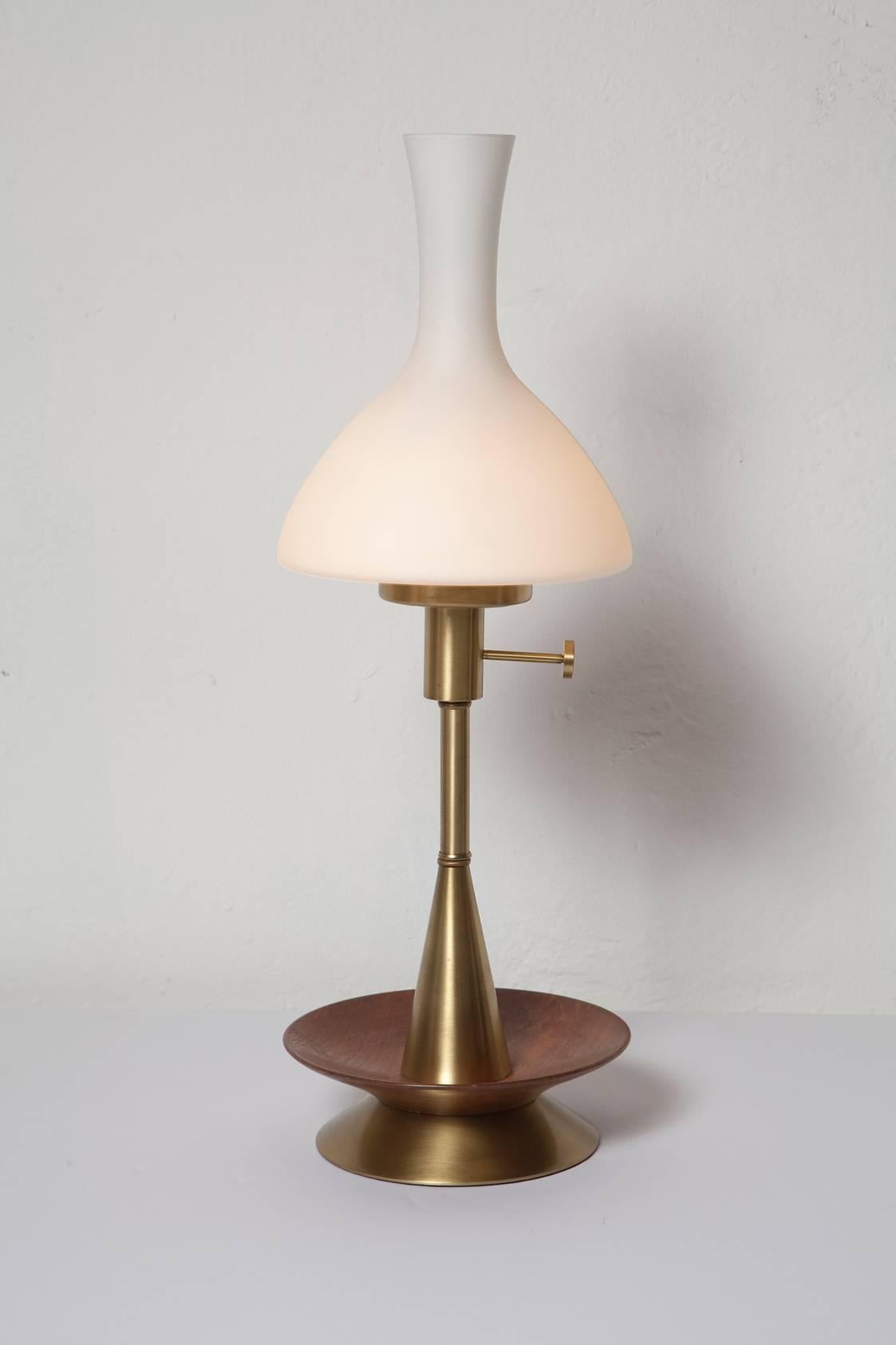 Often attributed to Paul McCobb or Lightolier, this clever 1950s brushed brass and walnut lamp charmingly marries both midcentury and antique elements in a way that we find perfect for cottage or cabin - from Nantucket, to the Berkshires, to the