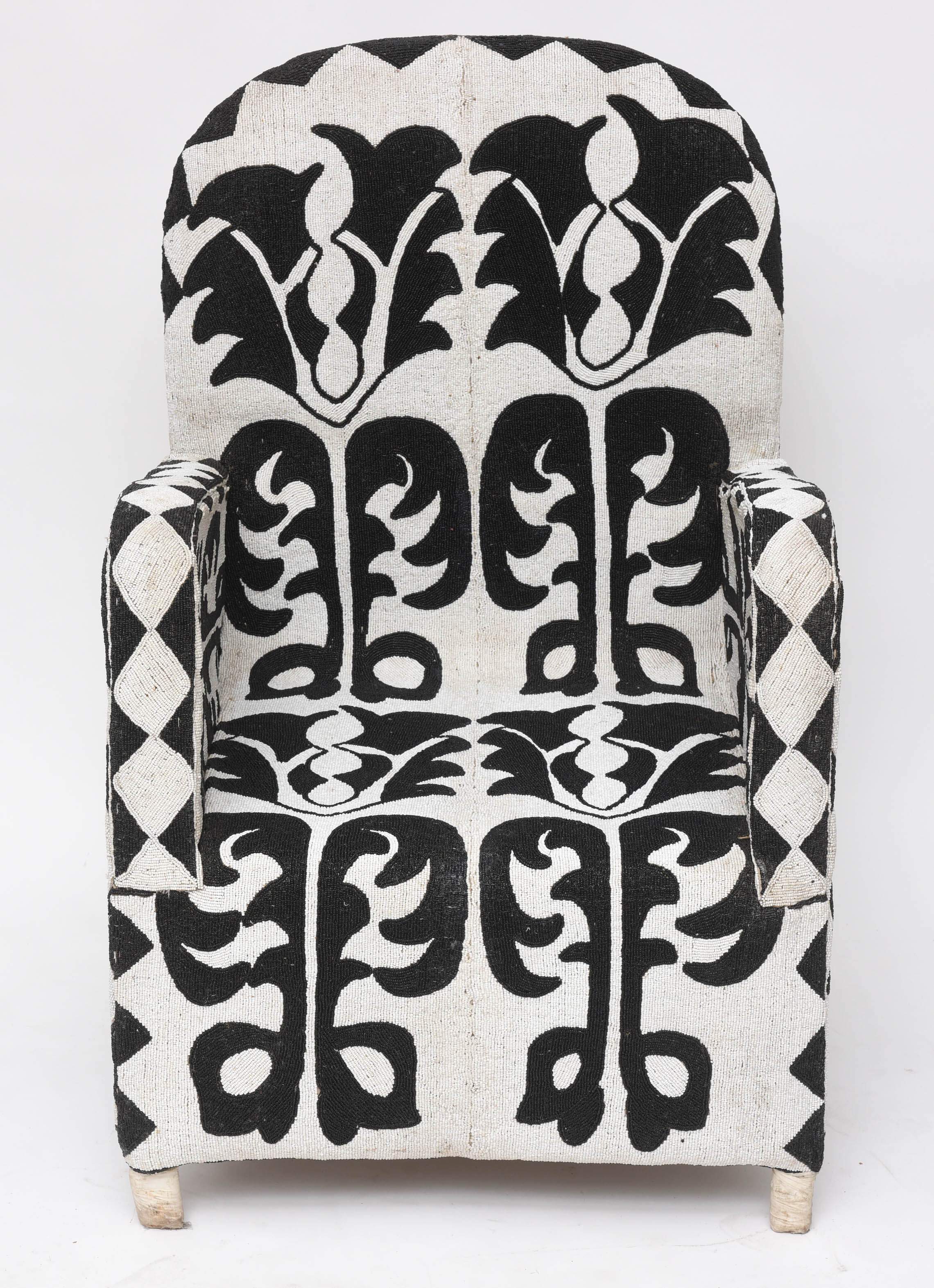 Striking pair of African chairs with a graphic abstract pattern, painstakingly executed in black and white glass beads over a wood and canvas frame.