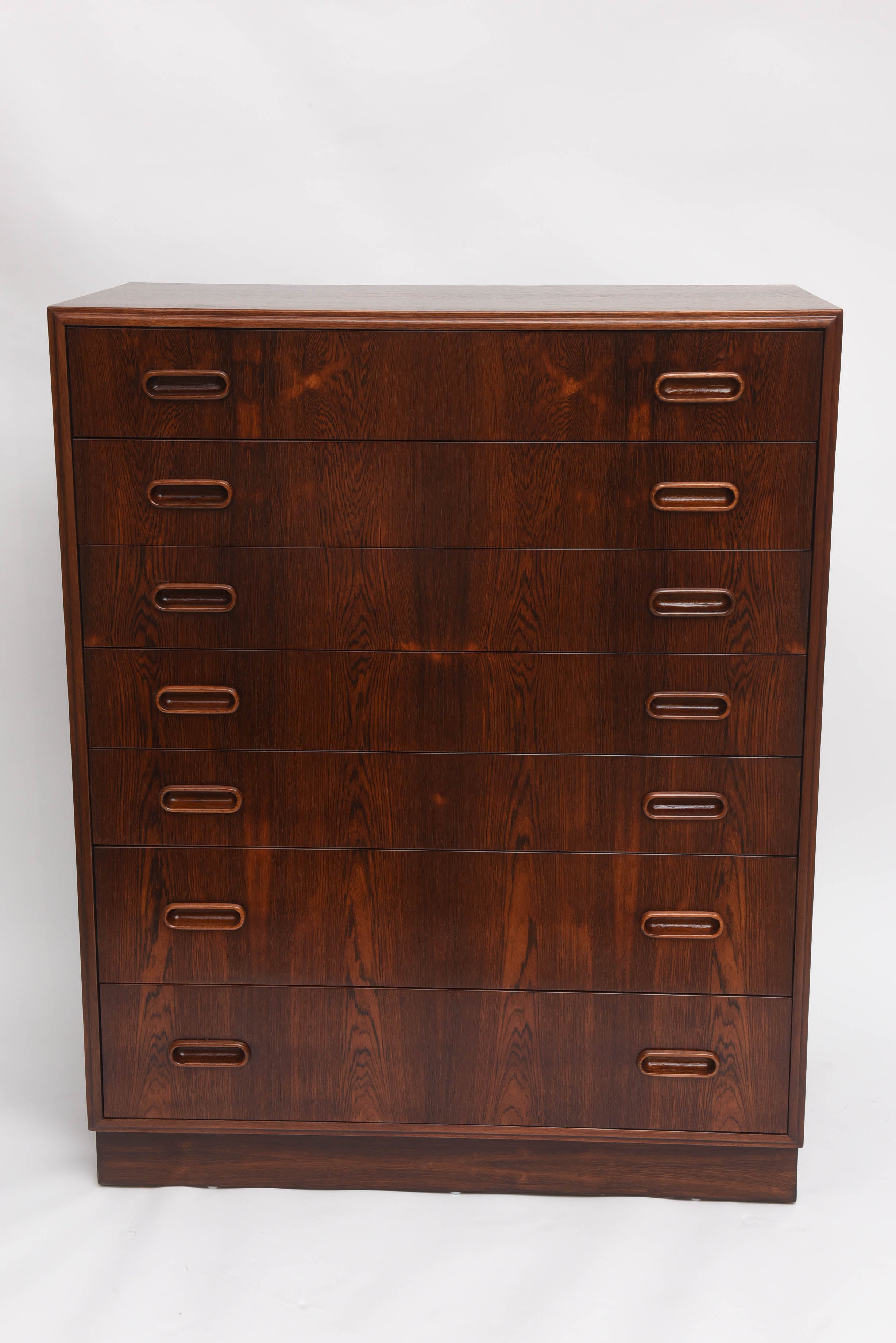 Beautifully restored Danish rosewood tall dresser with integrated wood handles.