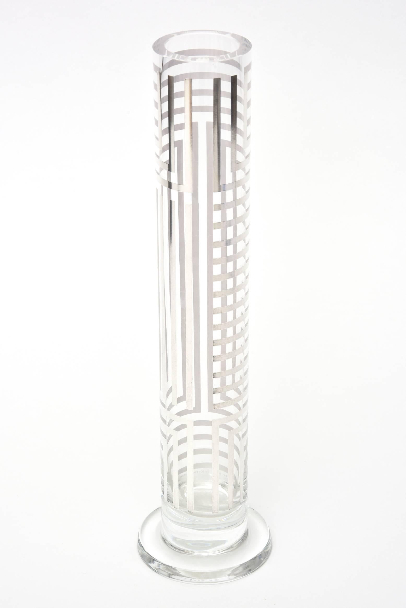 This wonderful stunning and tall architectural glass cylindrical vase and or bud vase is signed on the bottom Argento Flavia Alves de Souza for HWE Egizia by Sottsass Associati. It is sterling silver overlay in Greek key geometric form. The opening