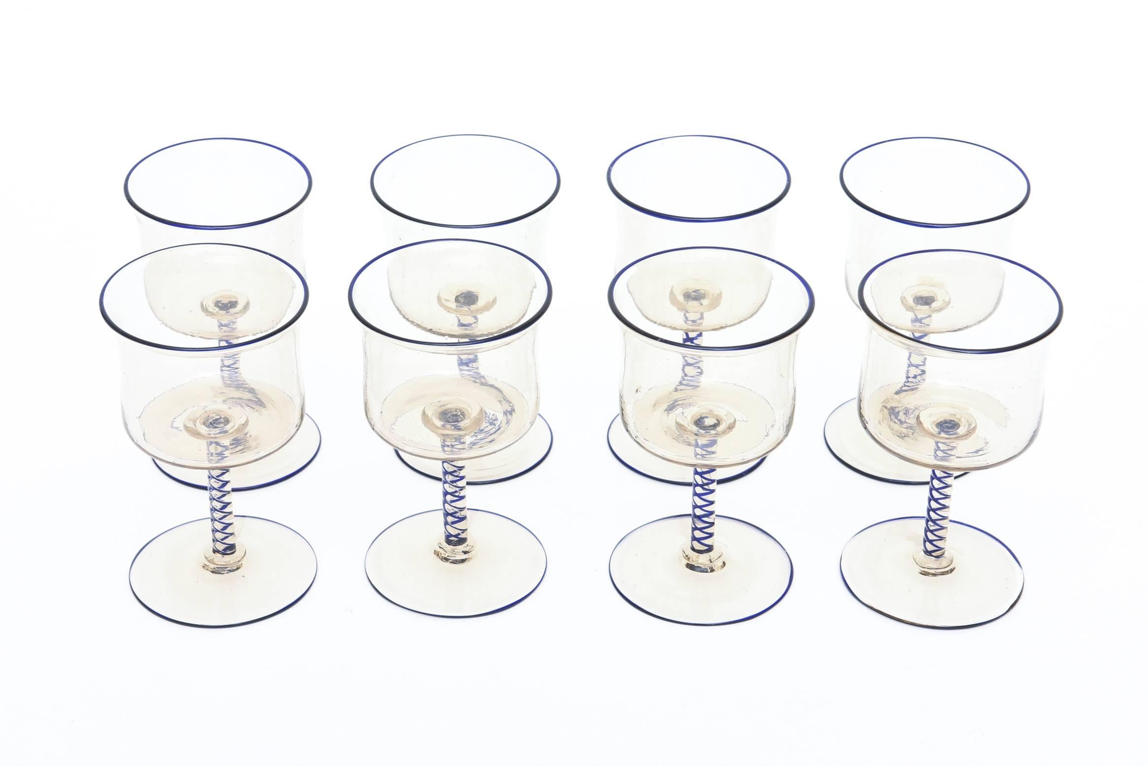 These beautiful vintage Italian cordial glasses are exquisite in person. Great barware! They have a beautiful delicate nature in form. They need to be appreciated in person.
They have navy blue criss cross Latticino stems and blue rims dusted with
