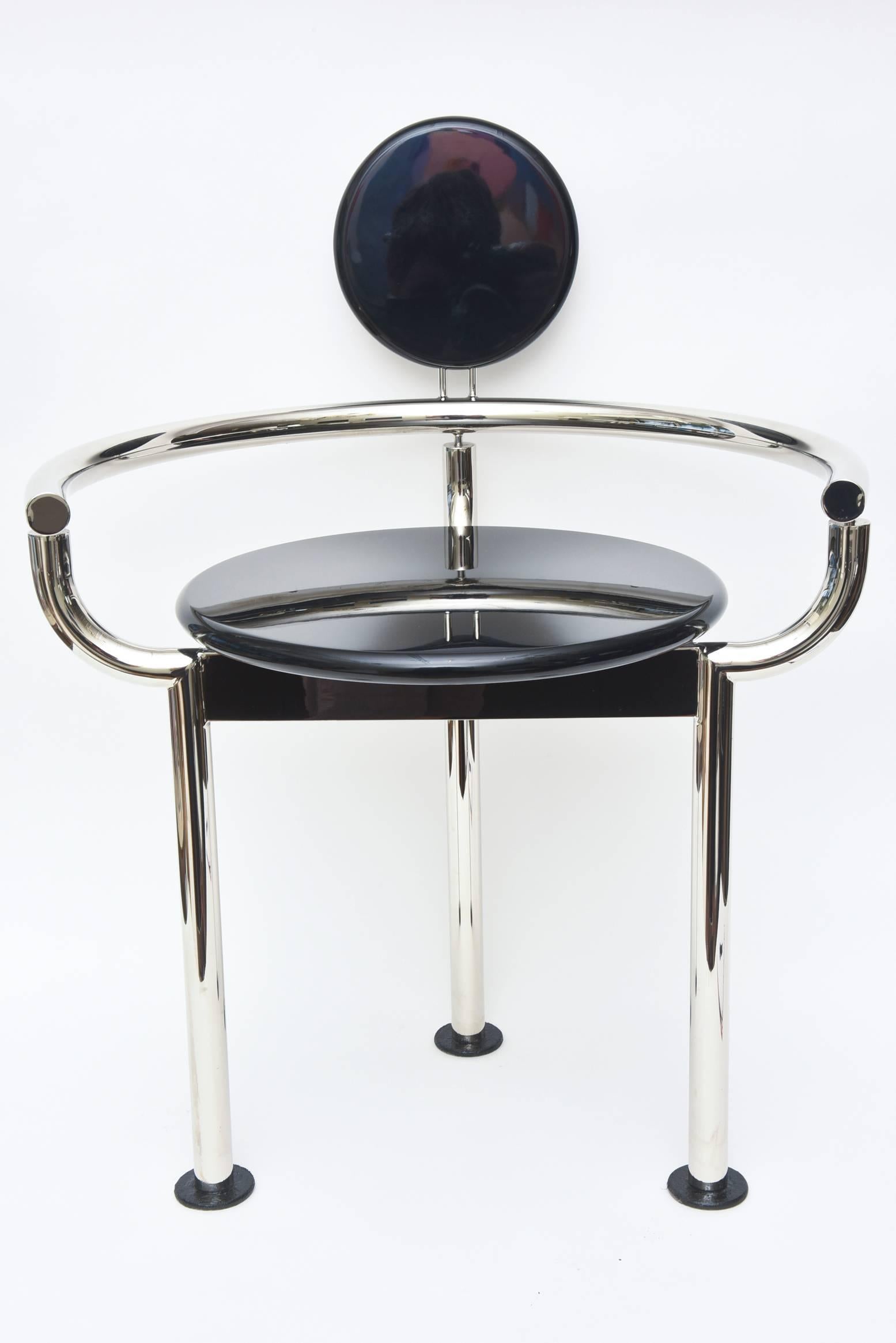 Memphis style meets art deco in this wonderful theatrical side chair that could be also used for a vanity chair or an accent chair.
The frame has been newly chromed and the circular pieces are black lacquered wood that has been restored.
     