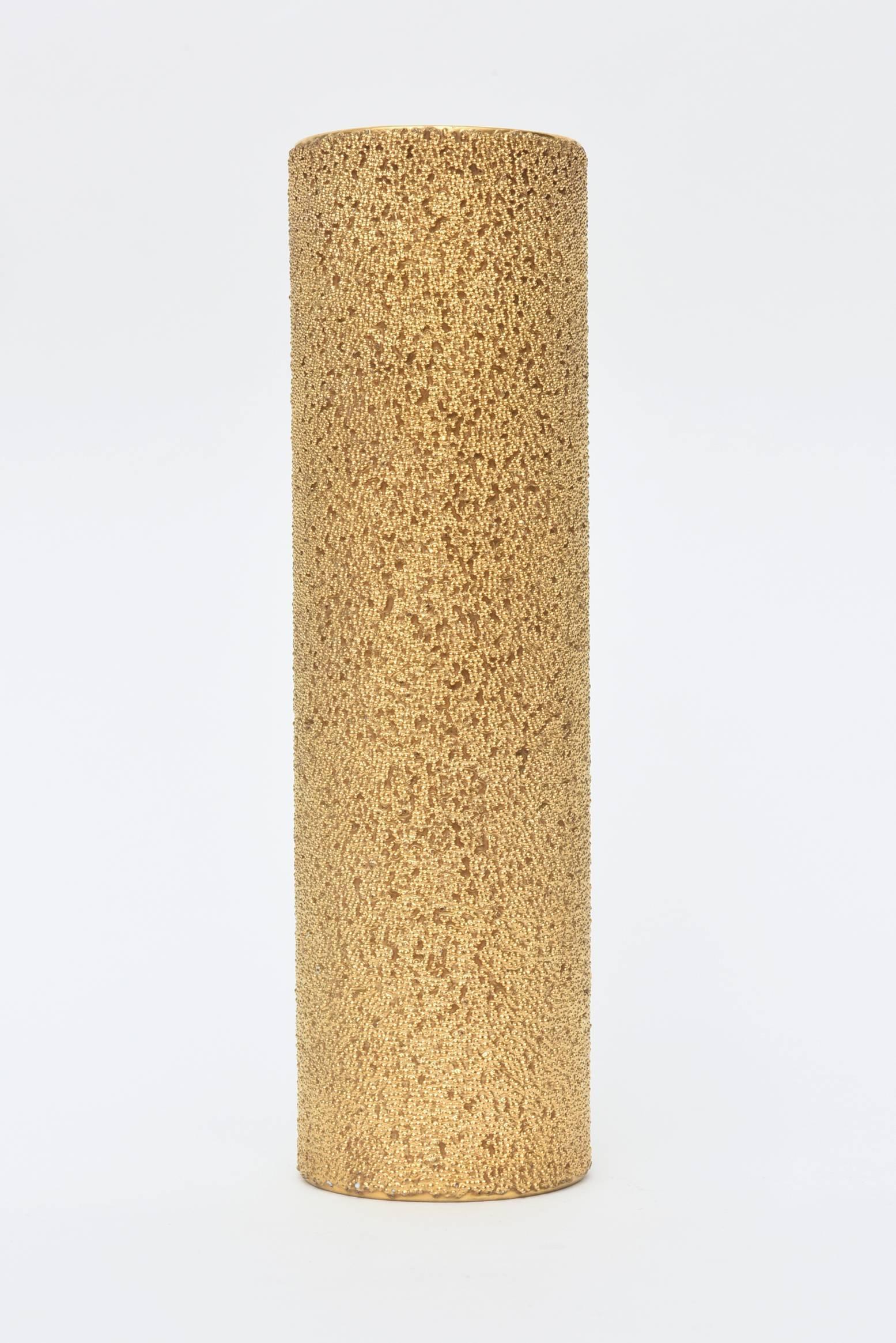 This beautiful rich looking column Rosenthal vase are beads of 23-carat gold over white porcelain. It is hallmarked on the bottom by Rosenthal Studio Line Germany. It is called the Goldenes Vies.
The layering and texture are gold beads in abundance