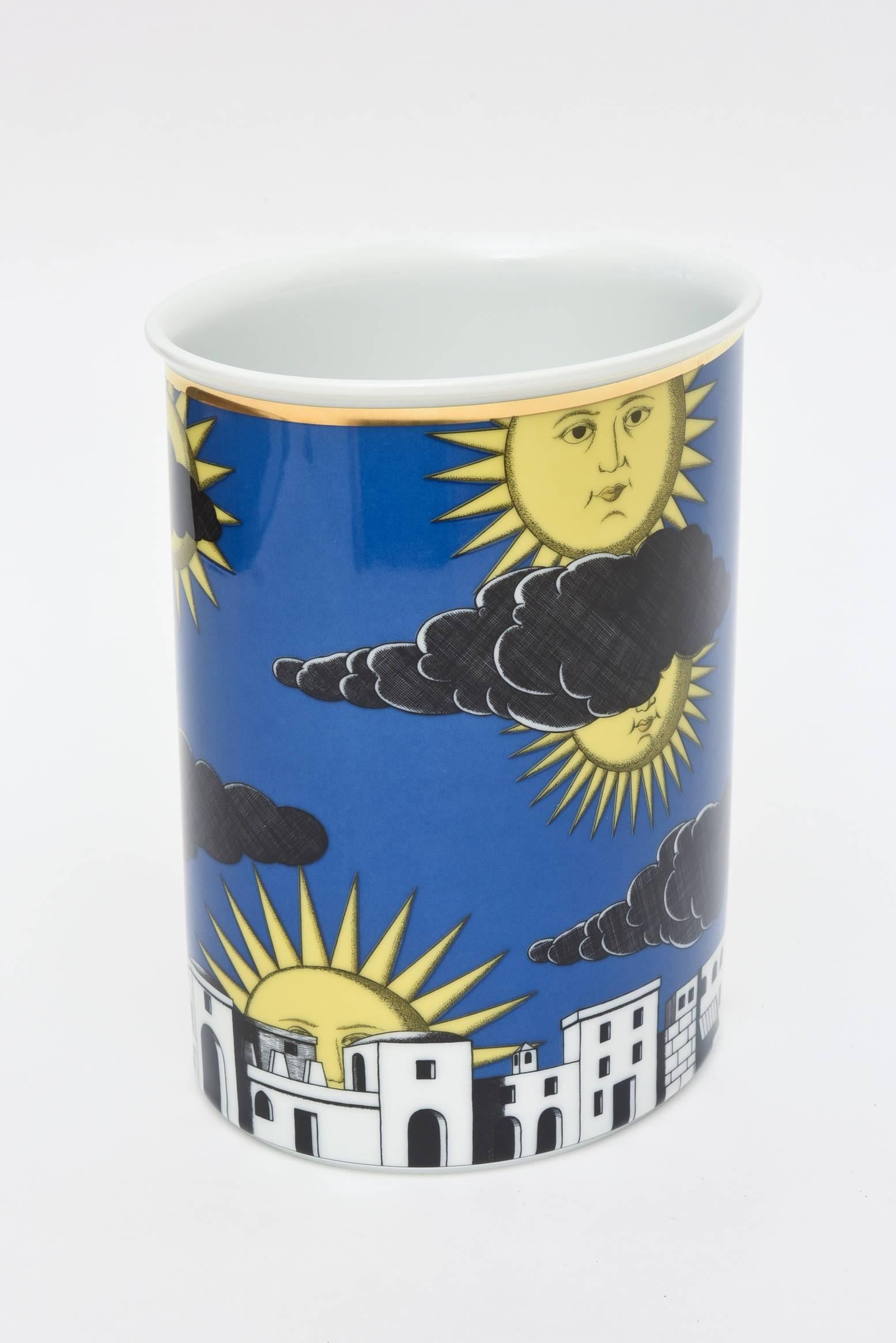 This large porcelain Fornasetti vase/vessel for Rosenthal Germany has a great depiction of the stylized architecture of Capri that meets the personified brilliant sun. The color combination of marigold yellow meets royal blue is most unusual.
It is