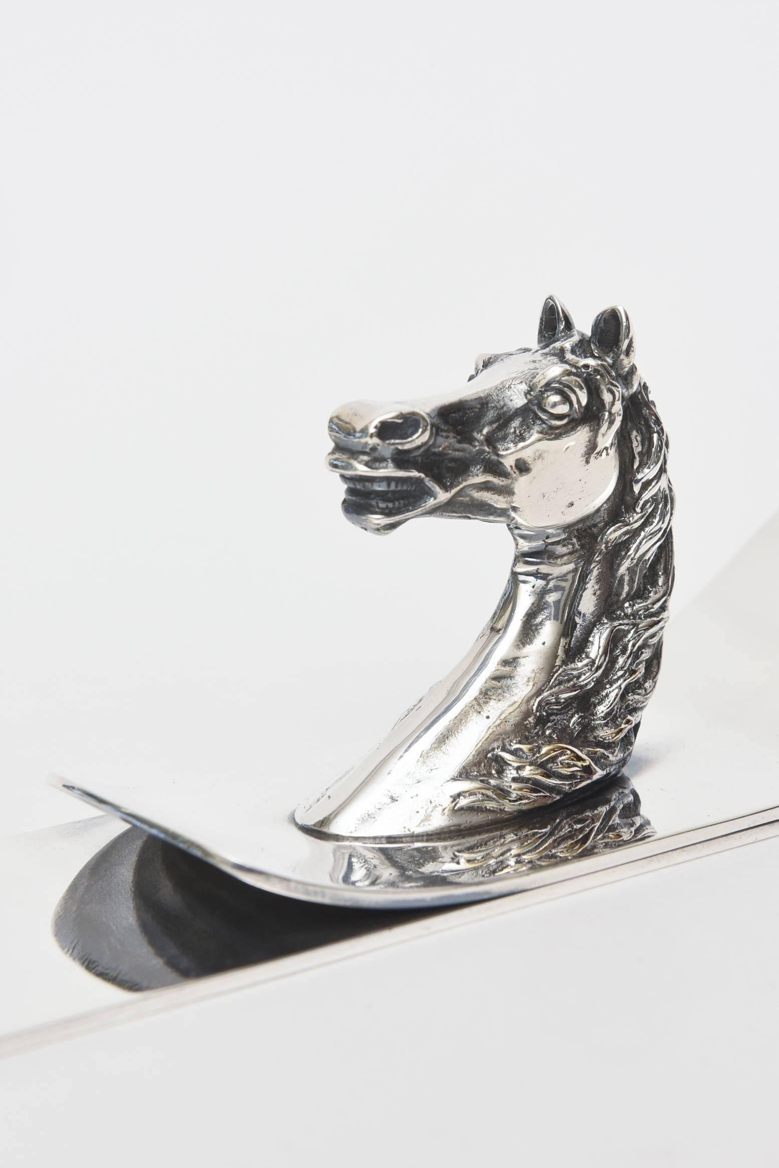 This wonderful vintage Hermès paper holder or letter clip is on the rare side. It is signed Hermès Paris and is polished silver plate. It was designed by Ravinet Denfort for Hermes. The elegant horse or equestrian bust that sits atop is stately.