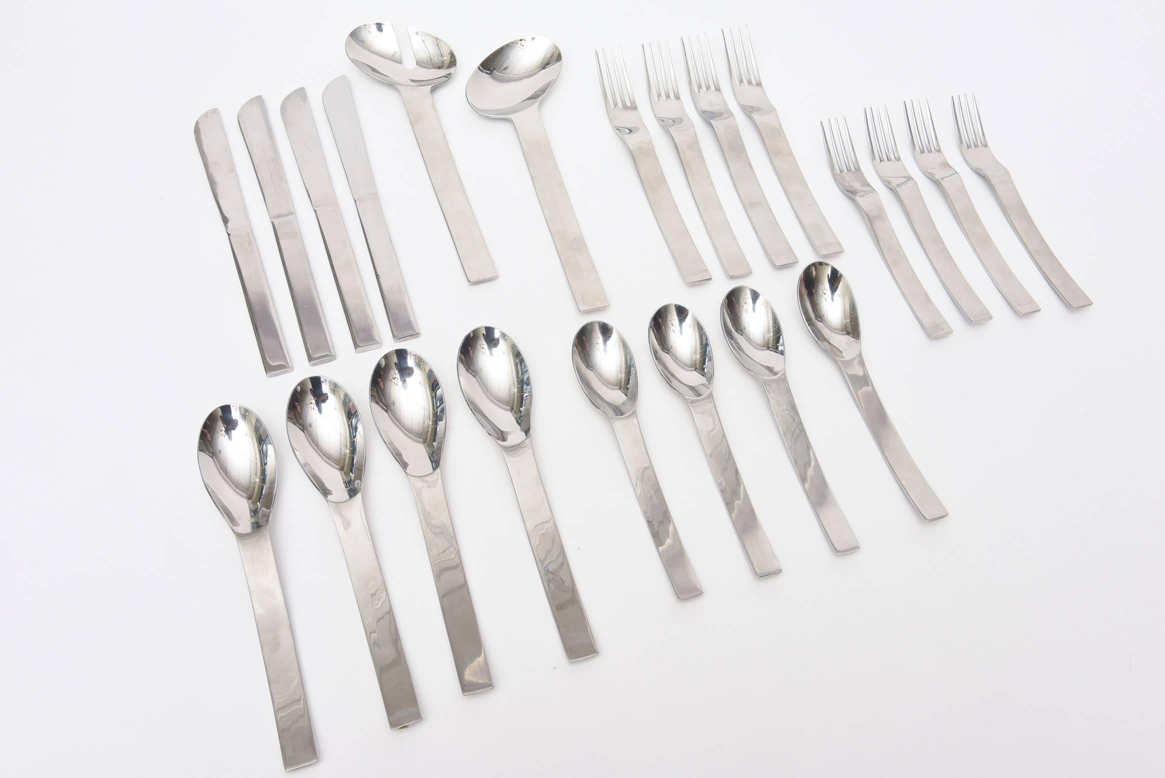 These vintage modernist stainless steel table settings is signed. It is from the late 1960s-early 1970s and was produced in Korea by Y. Kono Vignelli for Sasaki. There are 4 complete place setting s plus a few serving pieces for salad. There are 20