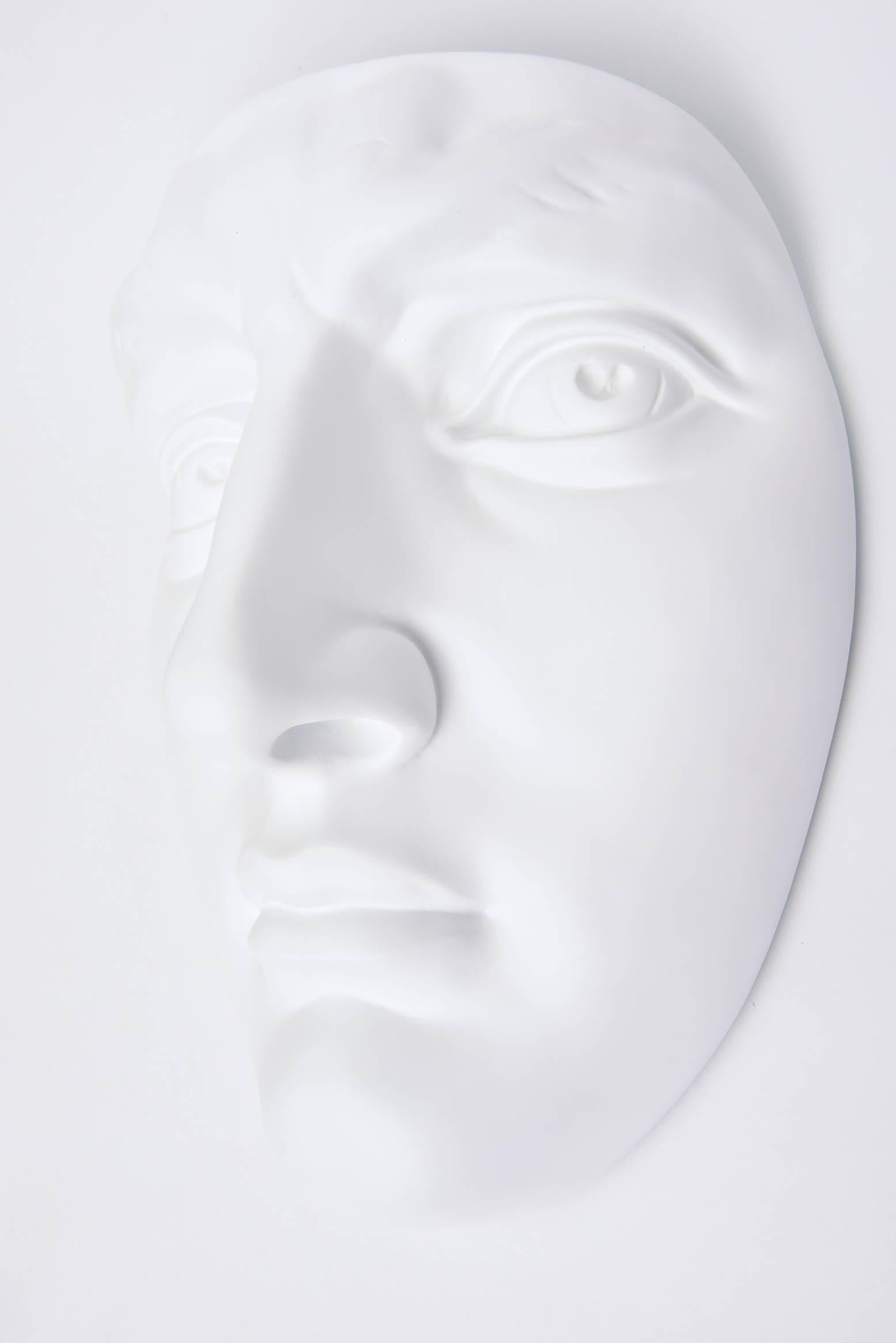 This vintage 1960s newly white painted resin and plaster of Paris face wall sculpture is from a company in Chicago. It is marked on the back. It makes an interesting decorative art wall sculpture. It has been restored.

 