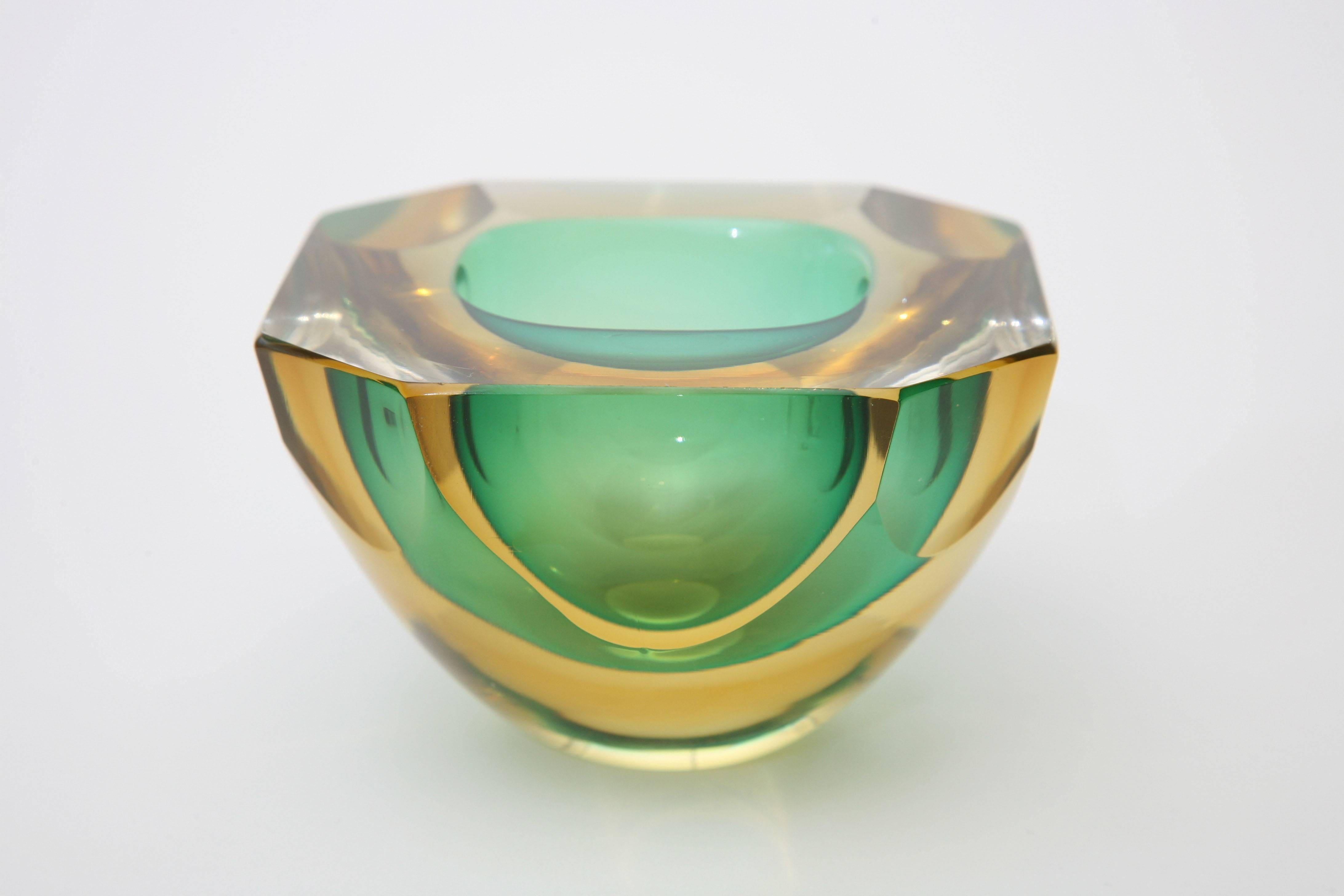 Lovely colors of Sommerso green to amber yellows are in this small Murano glass bowl that looks like a piece of sculpture.
It has a geode bowl with flat cut polished faceted sides and top.
Beautiful Murano glass!
Great for serving!