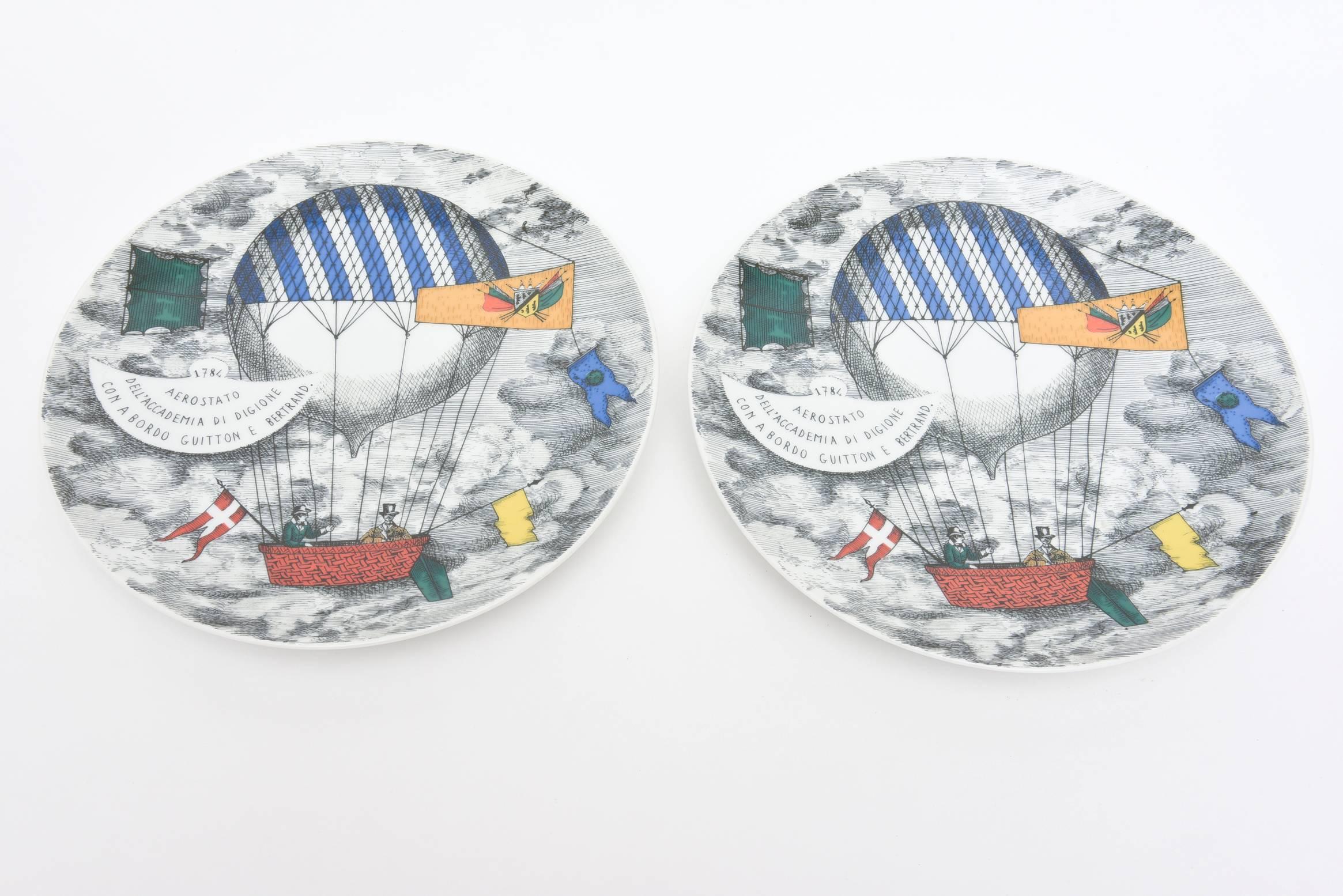 This pair of Piero Fornasetti for Rosenthal Germany porcelain plates are identical and are whimsical. They are for a hot air balloon race from 1784. Fun and great for serving. They are from the 1960s. These can also be hung on a wall.

 