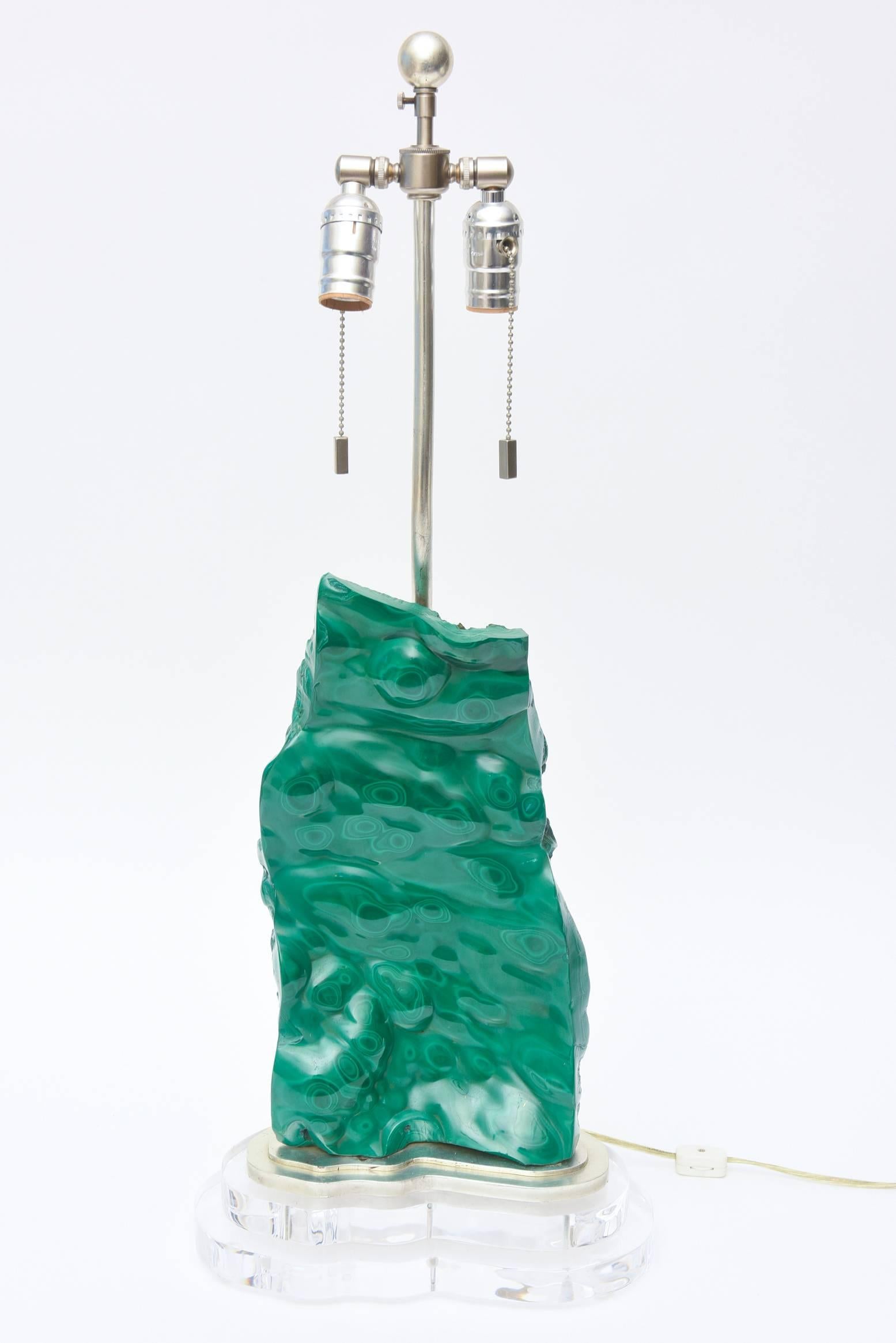 This stunning one of a kind lamp consists of a huge piece of exquisite Russian malachite as the body. It is mounted on a two step freeform Lucite base with silver leaf base in between. Malachite is a gemstone for the heart chakras. Malachite is