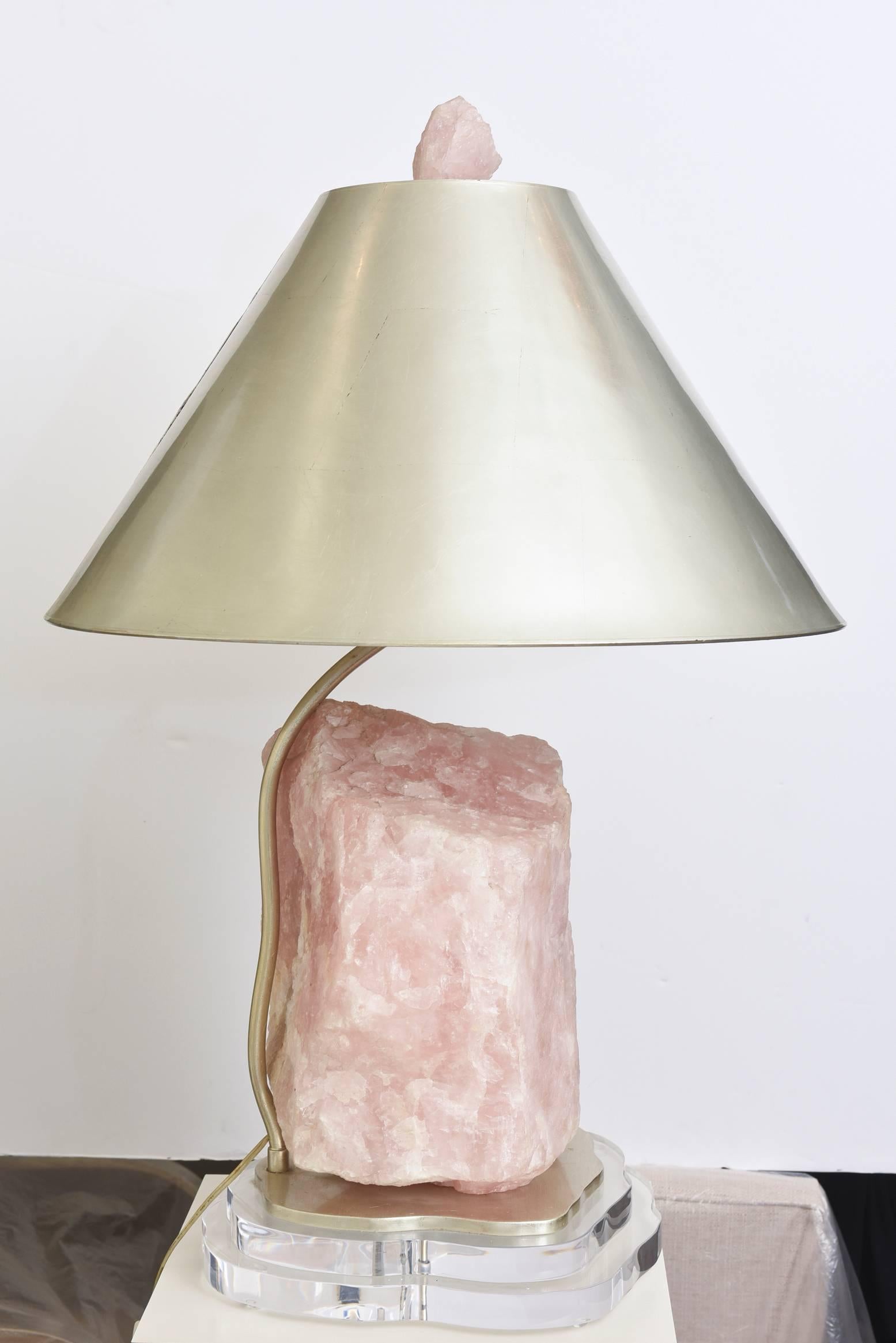 In this arresting one of a kind lamp made from one of the largest pieces of rose quartz that looks like a boulder is a table and or console lamp that brings about Love. The energy from rose quartz is amazing and the properties of that raw stone are