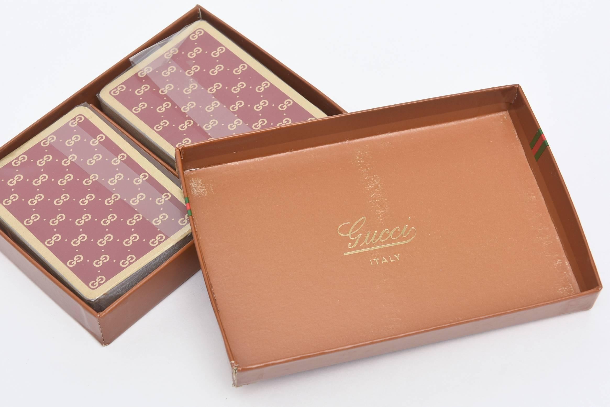 This lovely set of Vintage Gucci playing cards has not been opened. They are in a beautiful red/cranberry tone.
The iconic logo with the iconic banded colors of Gucci are on the top of the box.
The Gucci logo is on the paling with a gold band.
It