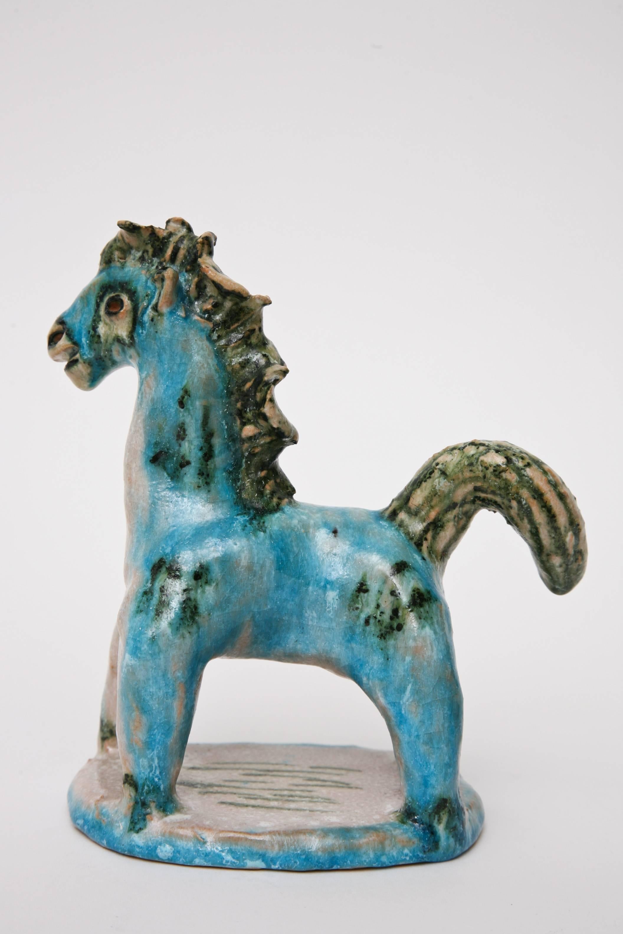 This small horse in beautiful hues of turquoise and shades of green paired with off-white and cream is a beautiful rendition of glazed ceramic by Guido Gambone 
is signed Gambone, Italy.
 