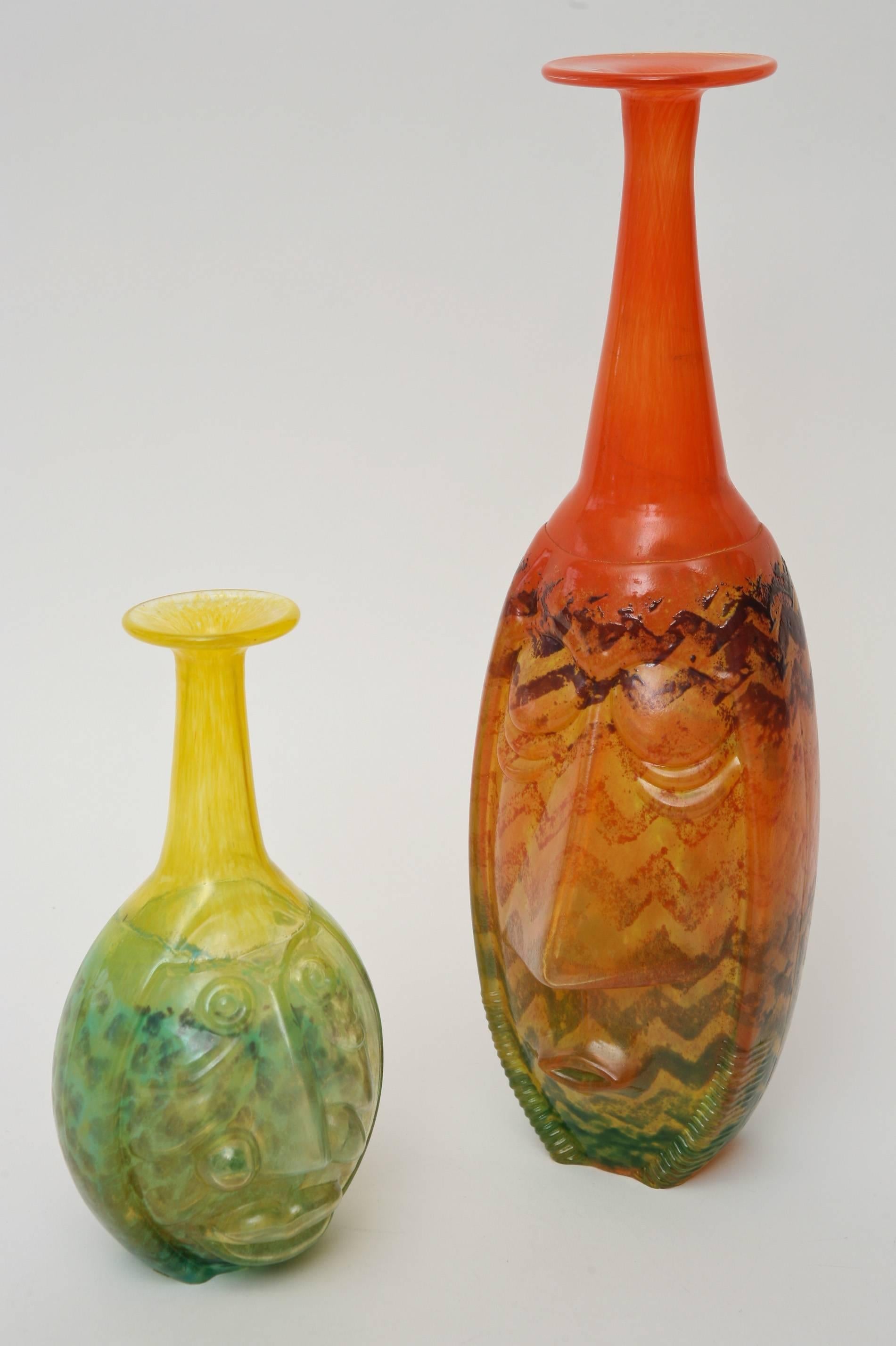 These absolutely stunning pair of signed hand blown glass vessels/sculptures by the renowned glass wizard and glass artist: Kjell Engman eludes carnival, masks and celebration. In light of what has just transpired from the glorious olympics that
