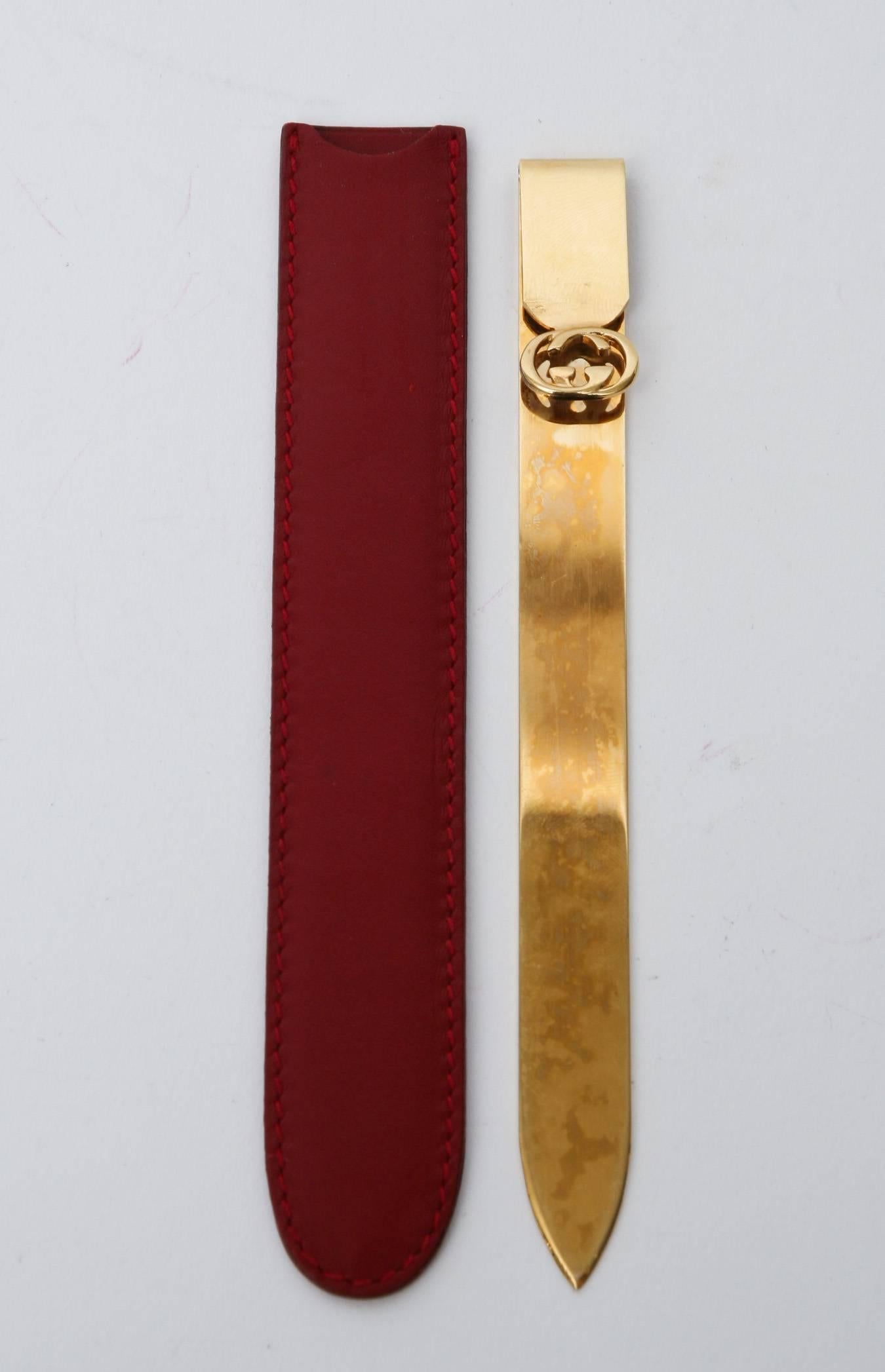 This iconic 22-carat gold-plated vintage Gucci letter opener has it's own red leather case. This makes a great desk accessory.
It says Gucci with a crest made in Italy.
This can also be used for a book mark and hopefully still people are still