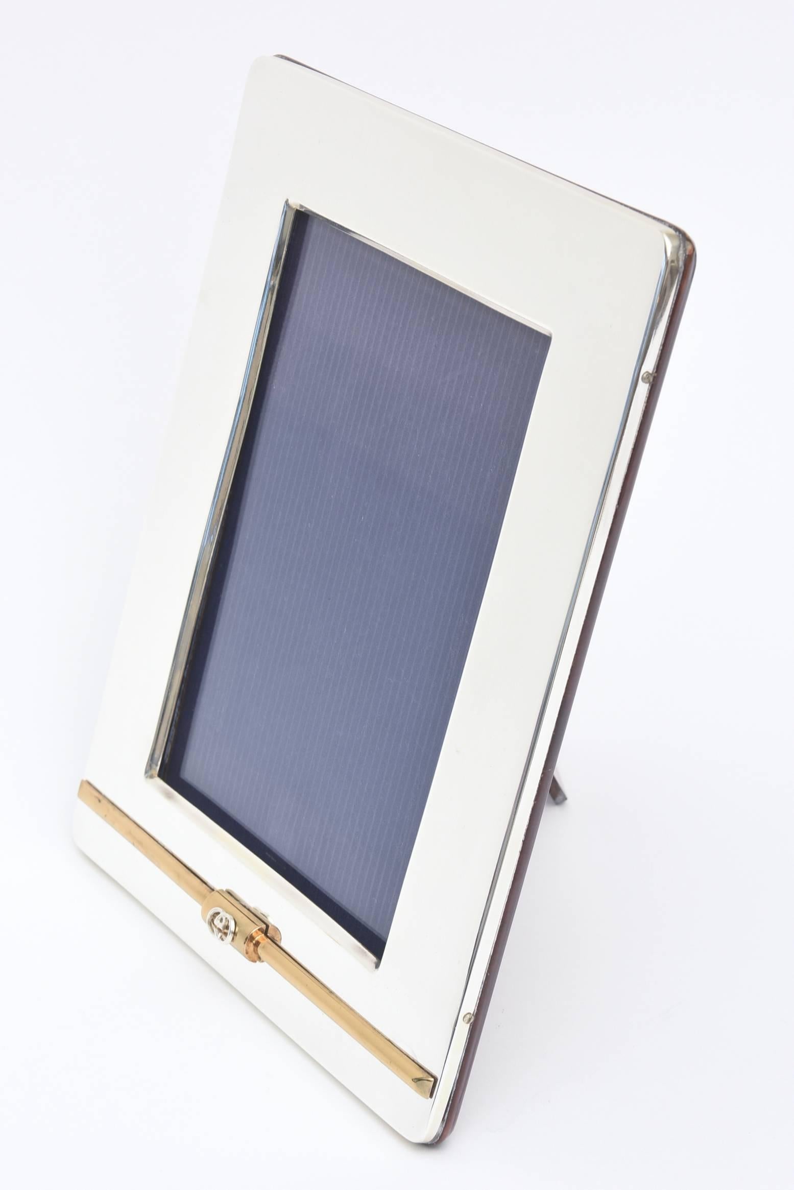 This lovely large Italian Gucci picture frame is simple and elegant. The 24-carat gold-plated bar on the bottom has all been redone as well as the silver plating. The GG's rest on the gold-plated bar. Fully restored as best as can be. The high gloss