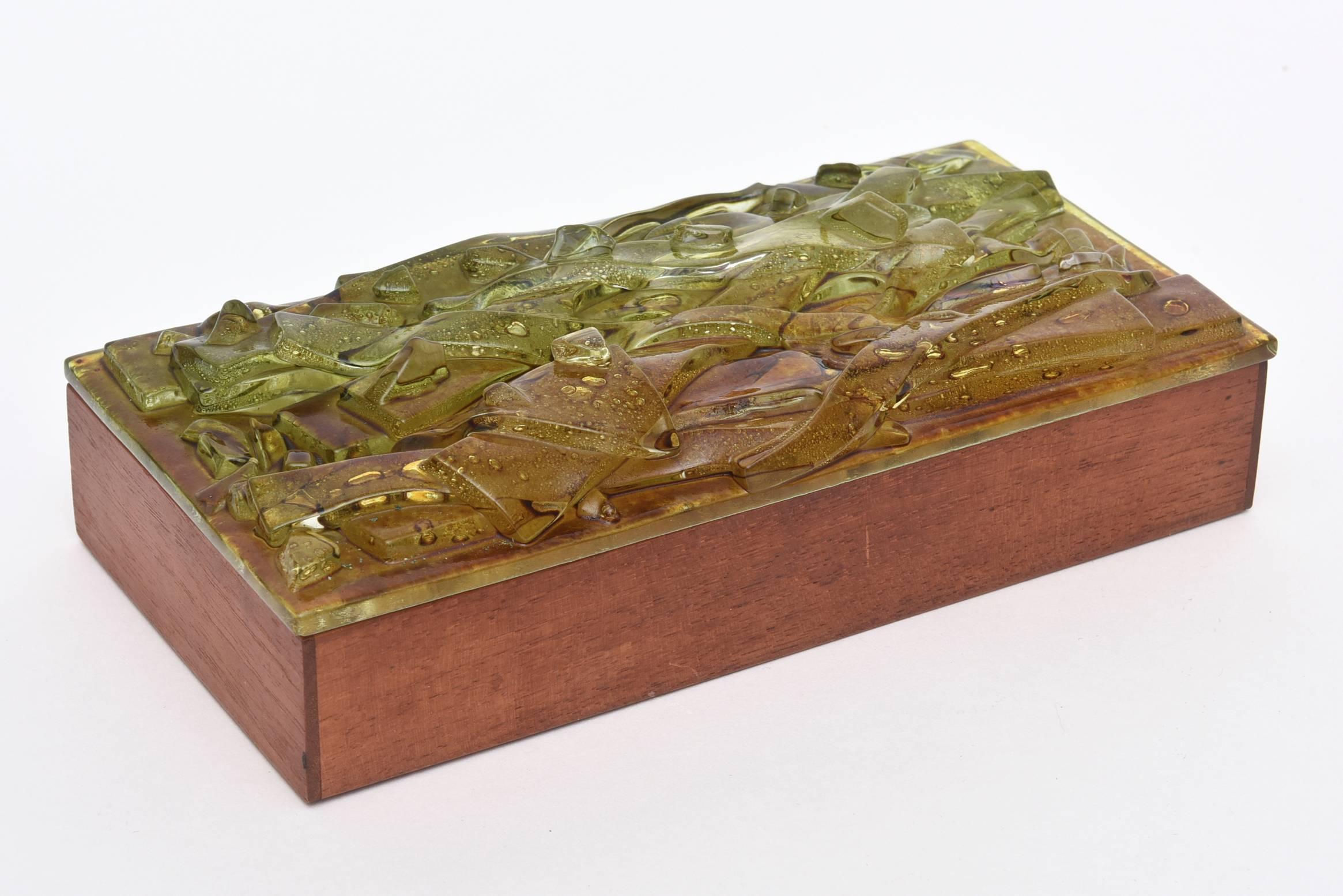 The beautiful vintage work of art fused glass on the top of the box is done by the artist: Robert Brown. It is so much in the style of Higgins Glass. The colors of the artistic fused glass are shades of green, amber cognac and brown. The original