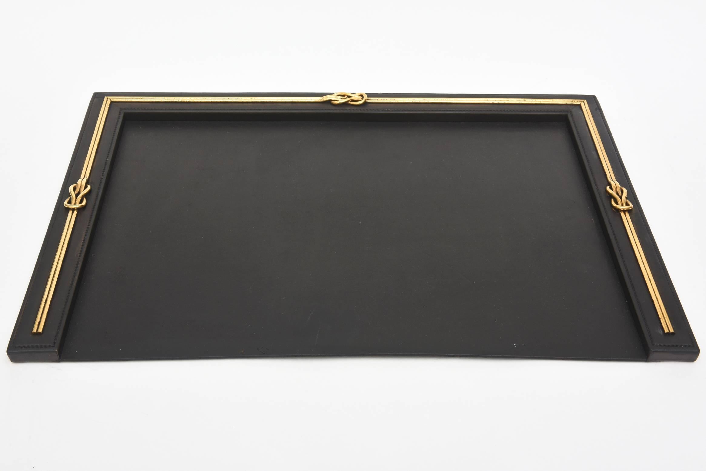 Black leather meets Gucci logo in thick heavy brass in this handsome vintage desk blotter, note tray holder and pencil or pen holder.
Sold as a set only. What a beautiful way to dress your desk. Perfect for a man or woman.
It is signed 
