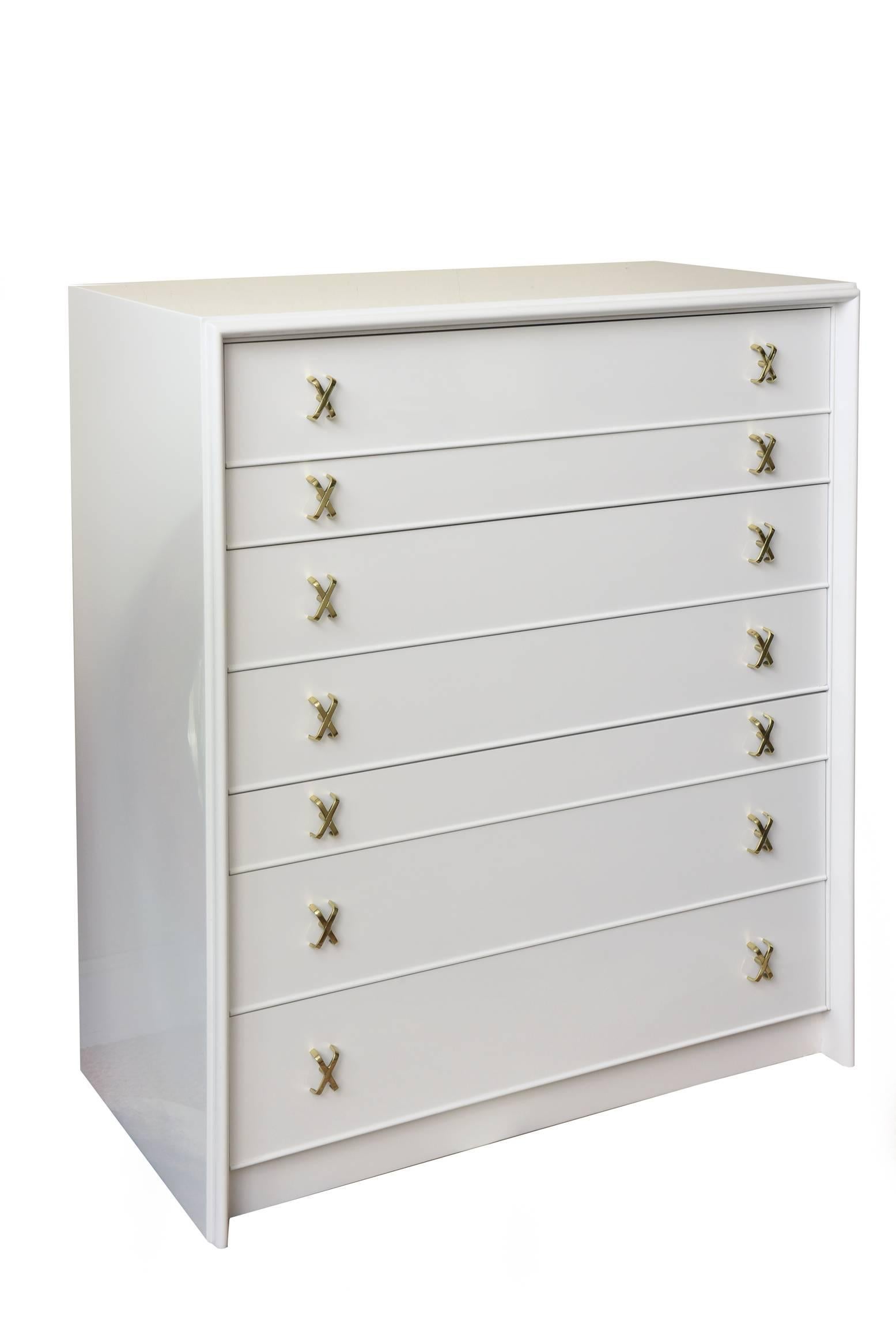 This high dresser by Paul Frankl for Johnson Furniture Co. consisting of seven assorted size drawers has been newly restored with white lacquer 45 with the iconic X-pulls in polished solid brass. It is Mid-Century that is so modernist and