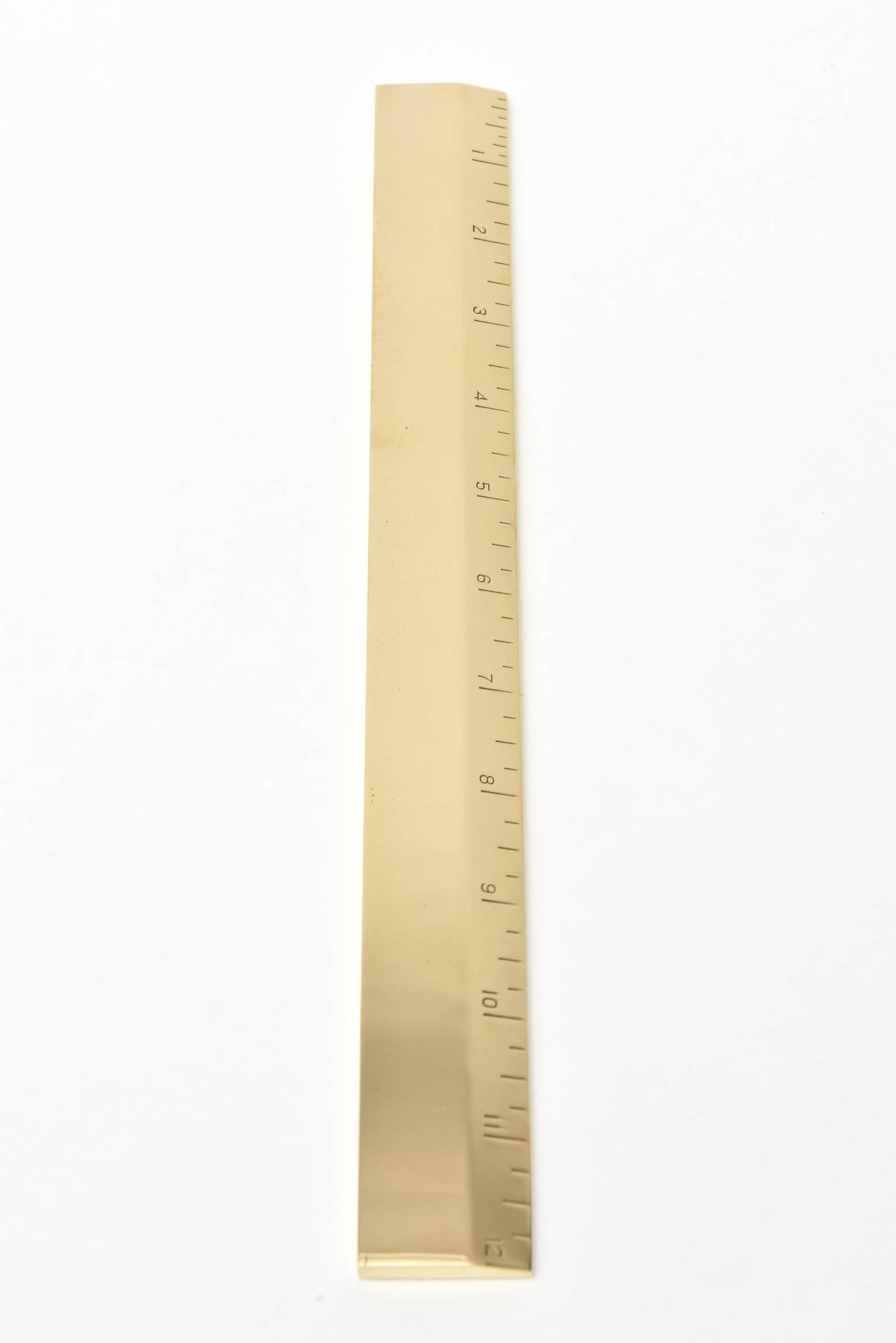This vintage solid brass and heavy ruler is Mid-Century Modern and from the 1950s. It has been professionally polished. It is a 12 inch ruler. Makes a great desk accessory. Could be used as a paperweight. The manufacturer is Artamount, NY.

  