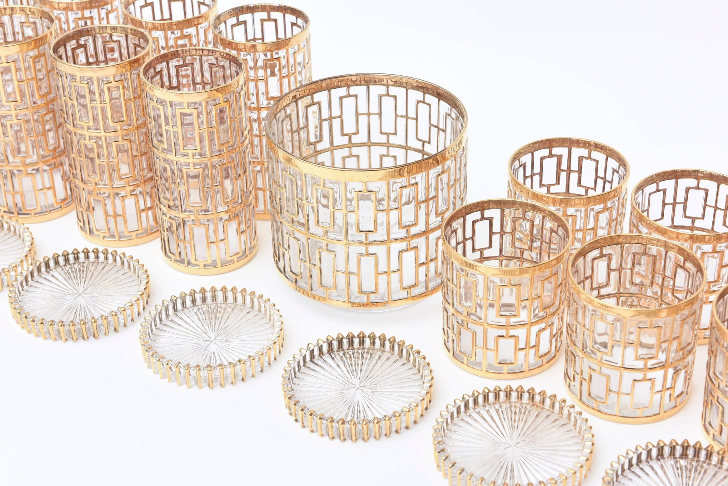 The heavy gold-plated Greek key/shoji screen design over clear glass is very
Moderne now even thought it is from the 1960s.
It consists of an ice bucket, eight tall glasses, eight highball and the most important is
eight coasters that match this
